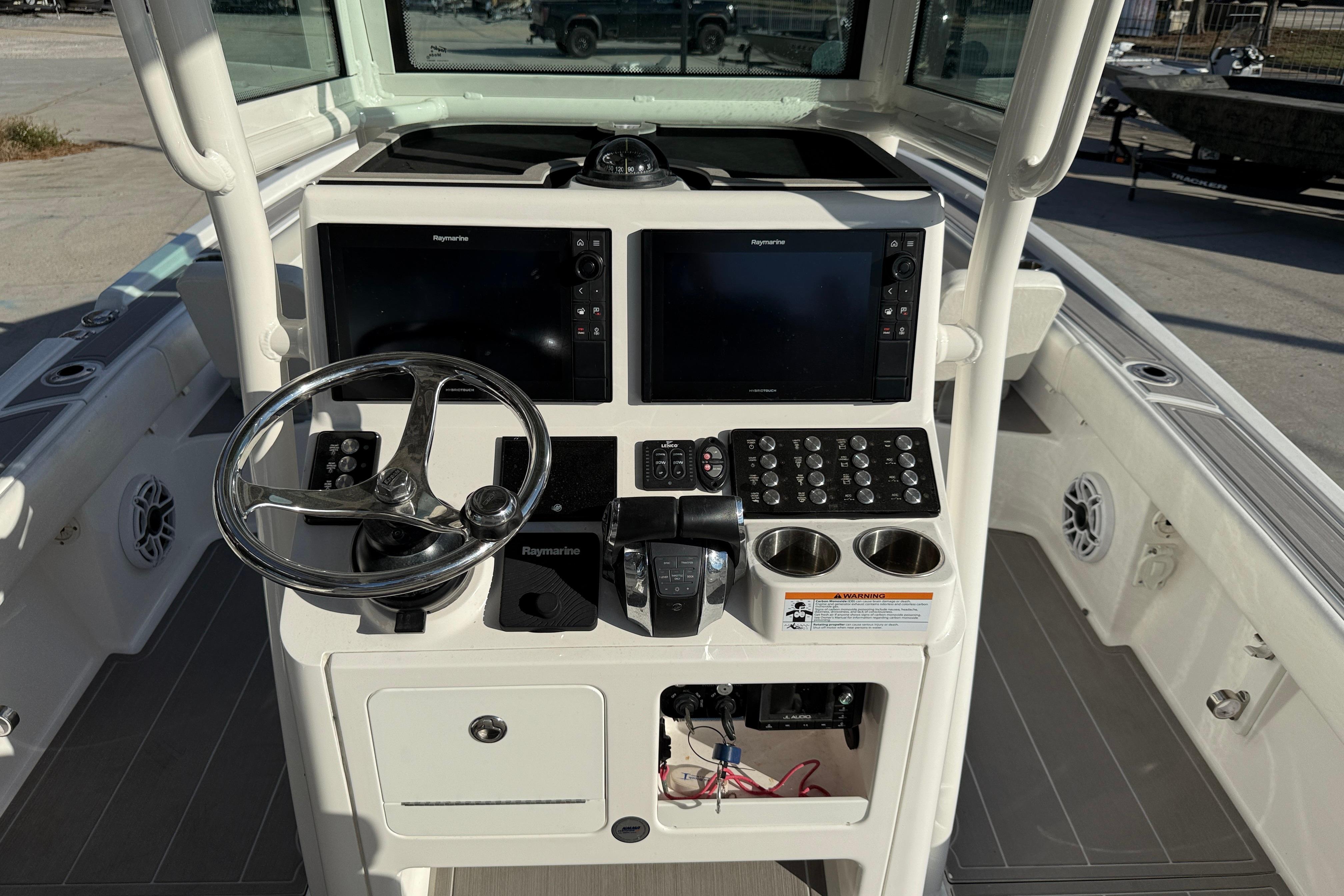 2022 Caymas 28 HB Twin boat console with steering wheel and Raymarine displays.