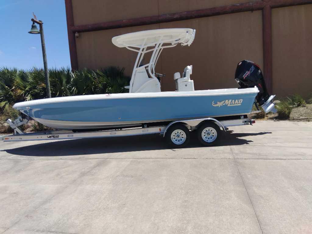 2025 Mako 24 APEX boat on trailer, blue hull, outdoor setting.