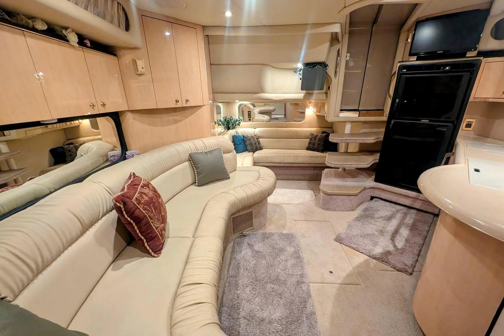 Luxurious interior of a 2000 Sea Ray 380 Sundancer yacht with plush seating and modern amenities.