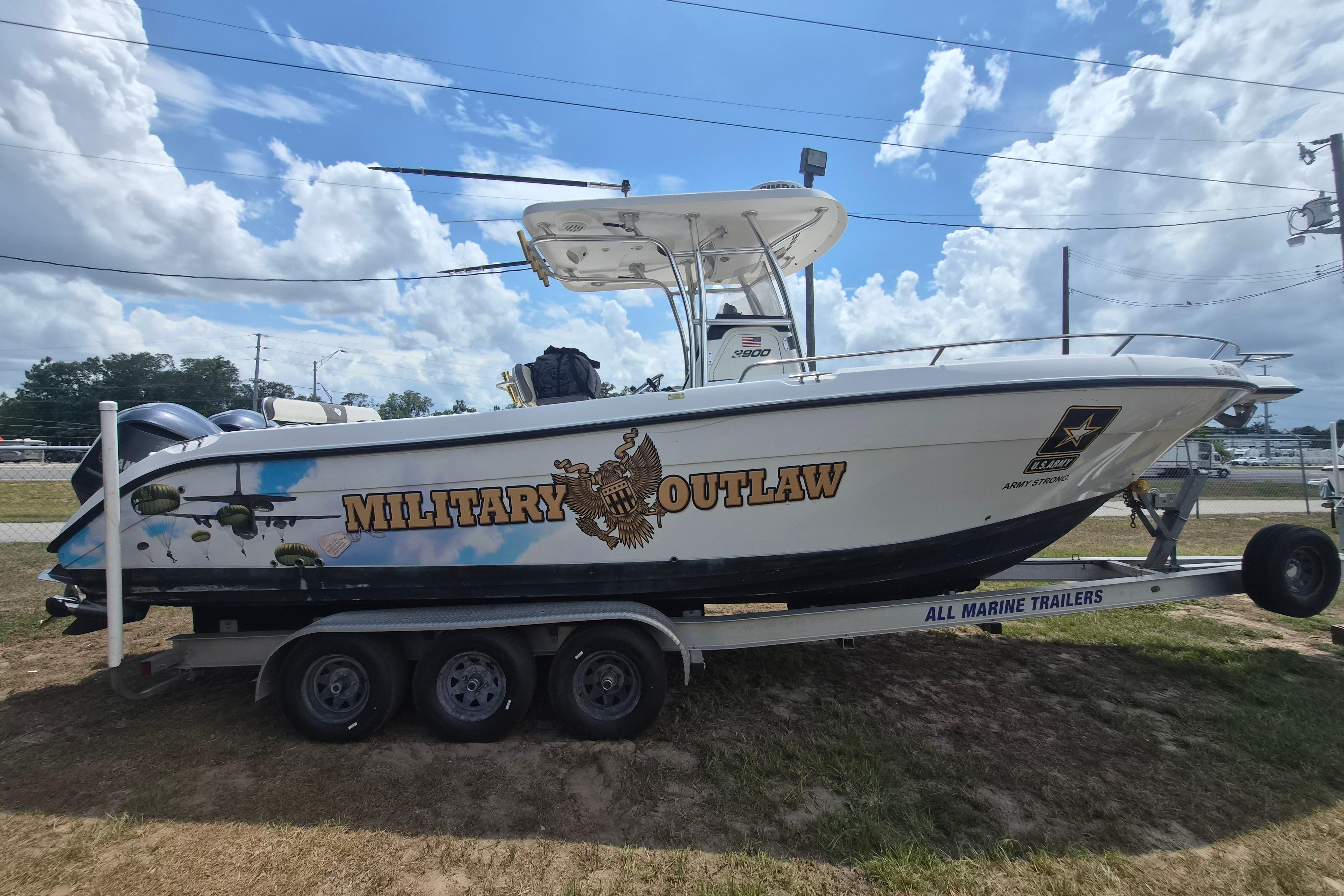 2006 Century 2900 Center Console boat on trailer, labeled "Military Outlaw."