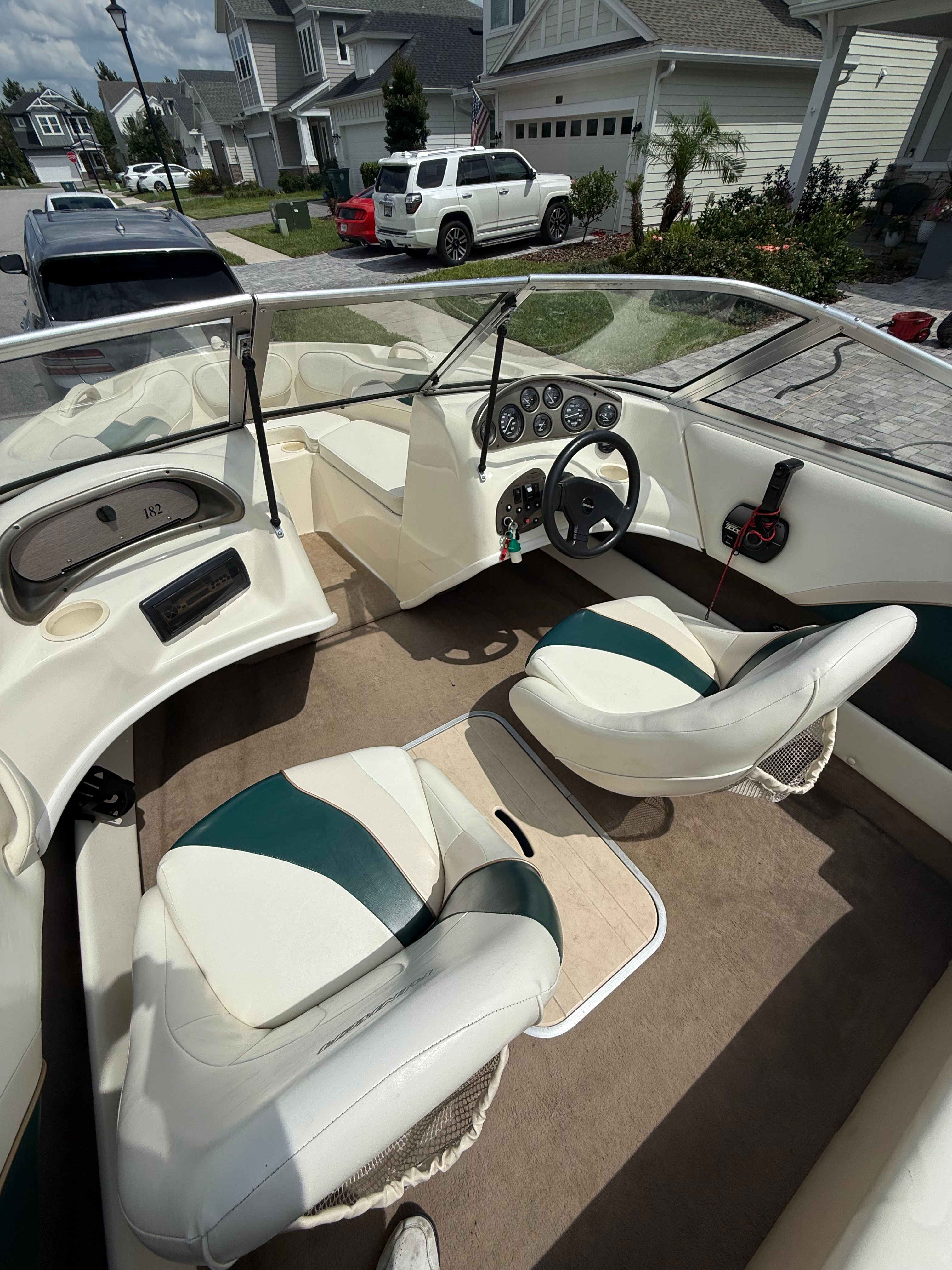 The interior of a Rinker Captiva boat with two seats and a steering console.