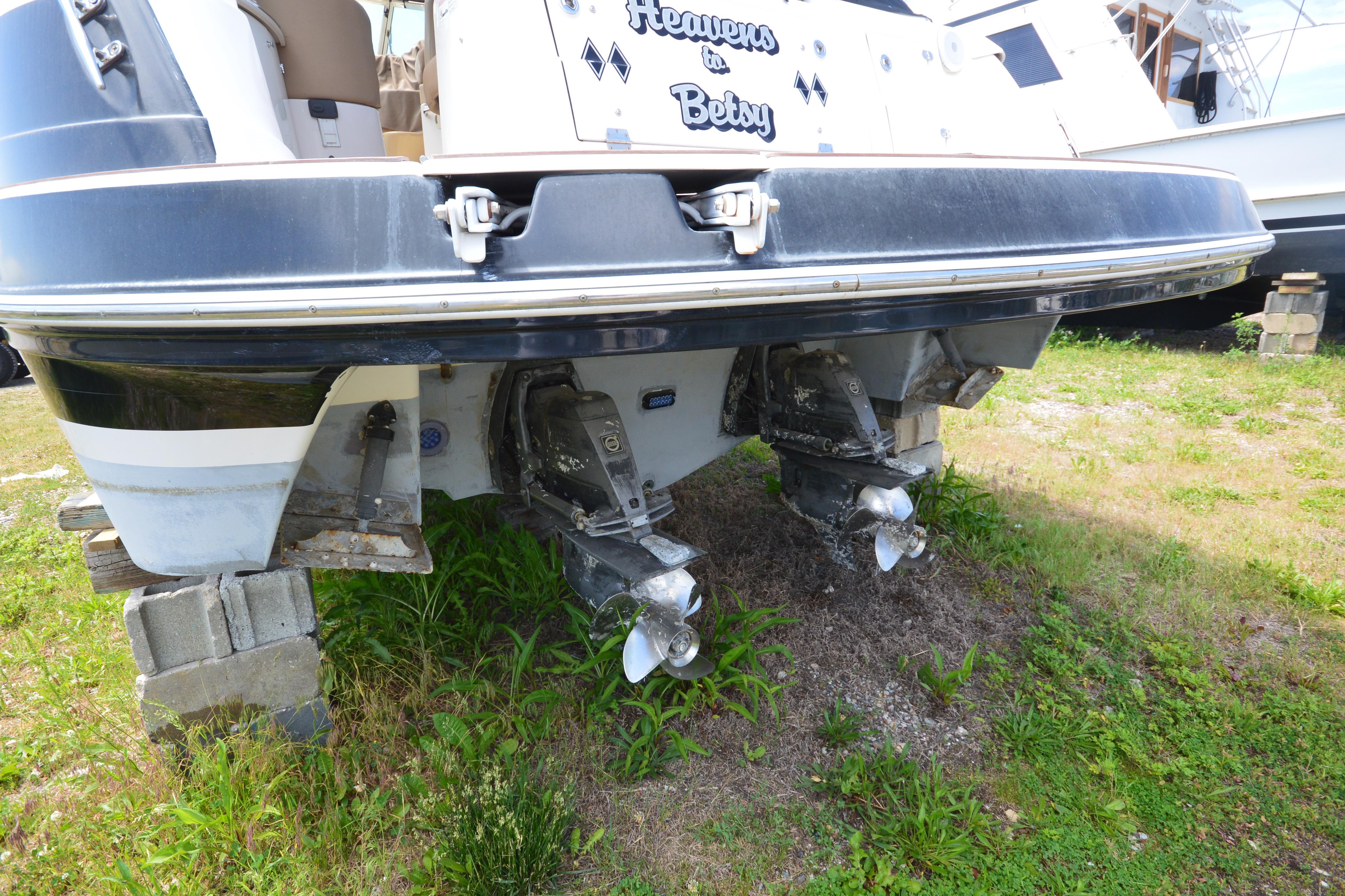 Rear view of 2013 Four Winns V375 boat on blocks, showing dual propellers.