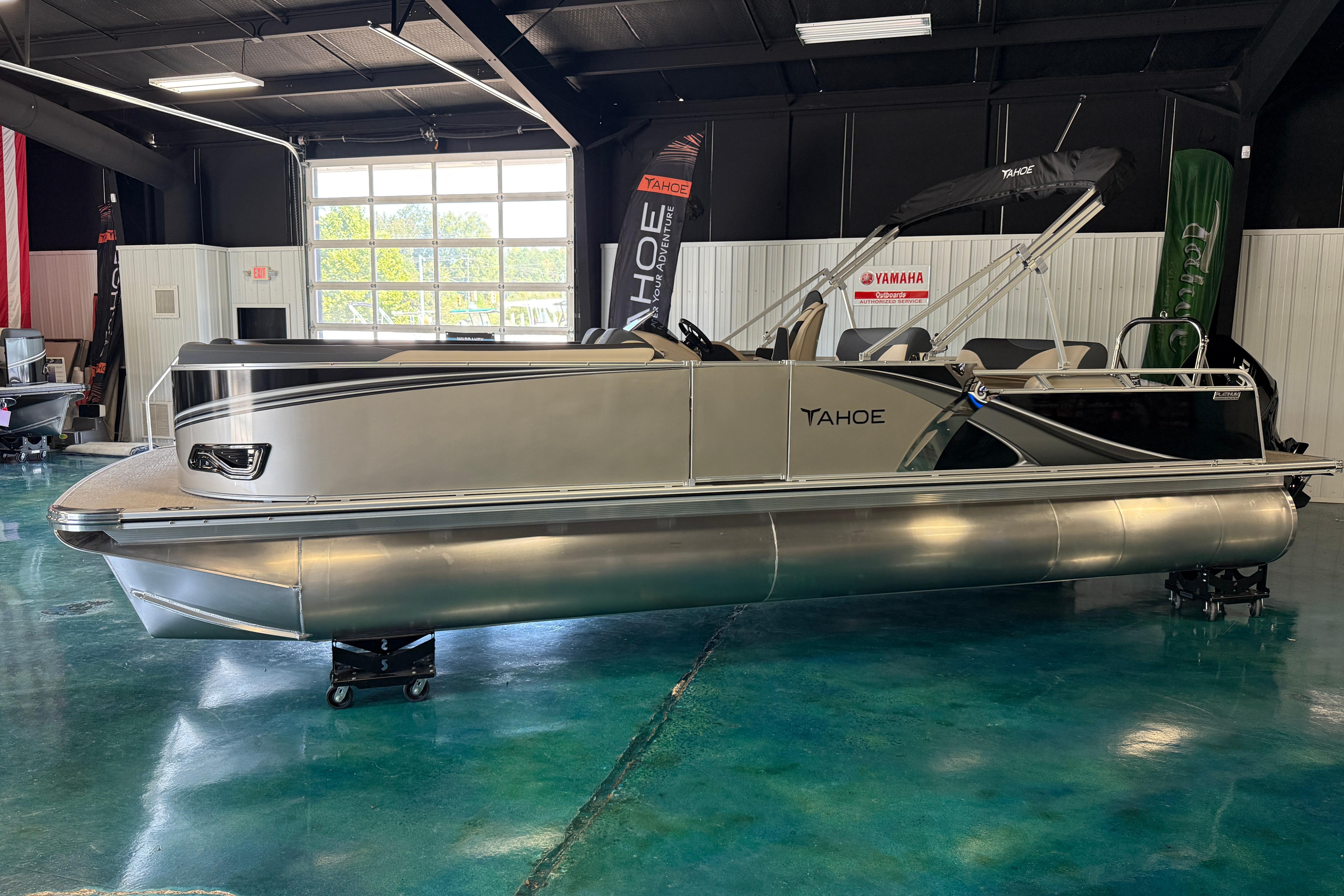 2026 Tahoe Pontoon LTZ Entertainer in showroom, sleek design, modern features.