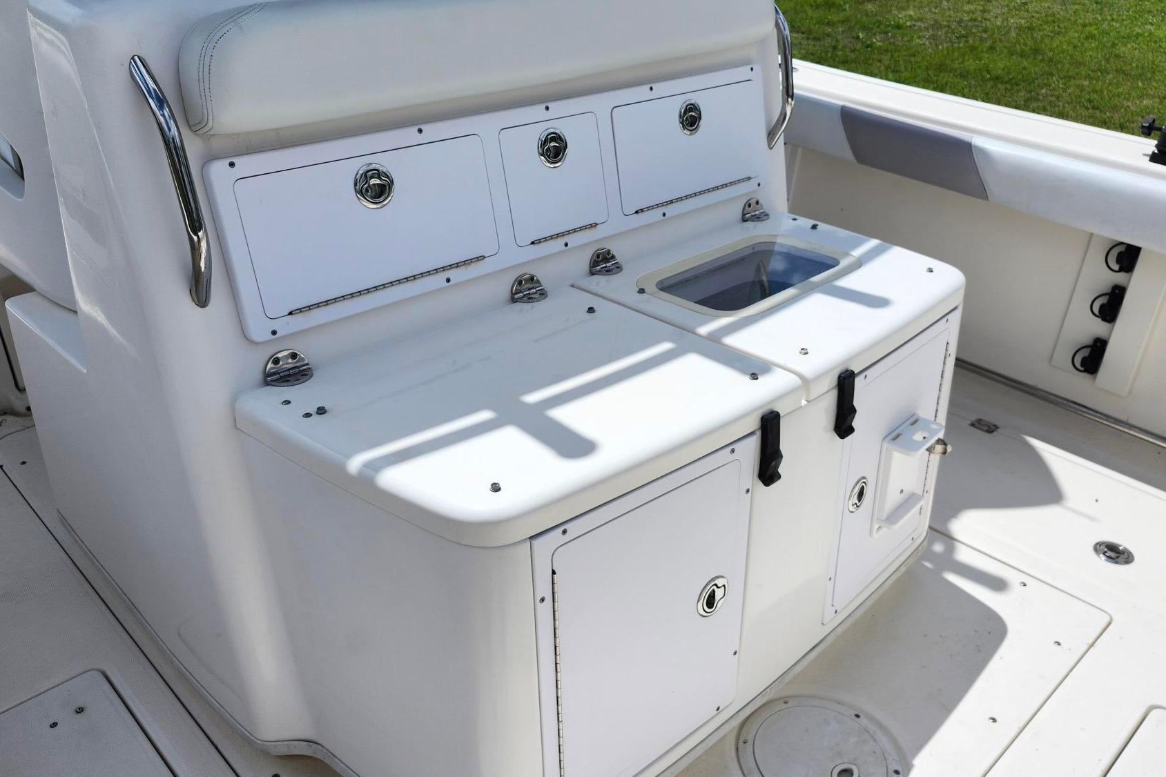 2015 Robalo R300 Center Console boat interior with storage compartments and seating.