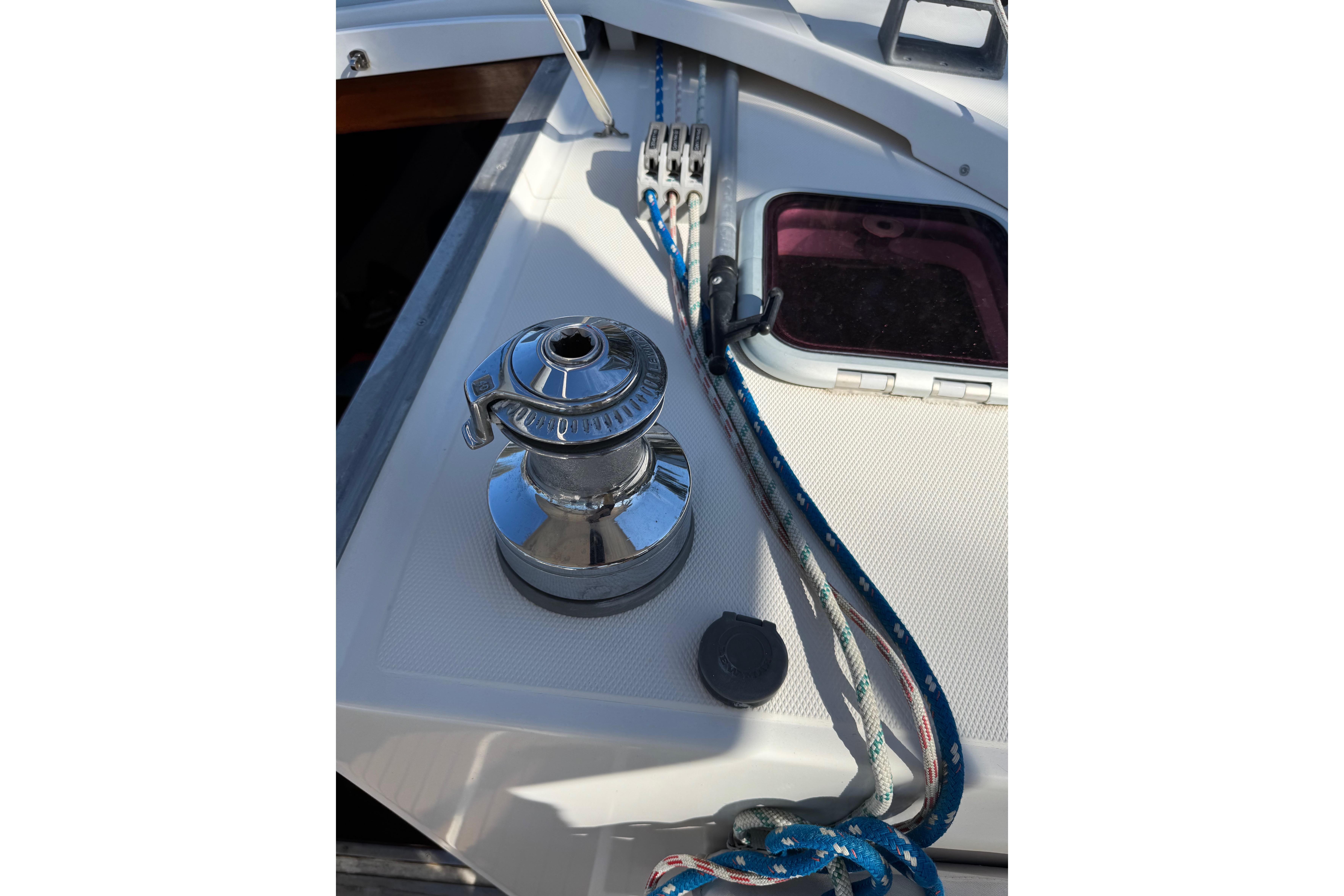 Winch and ropes on 2006 Shannon Shoalsailer sailboat deck.