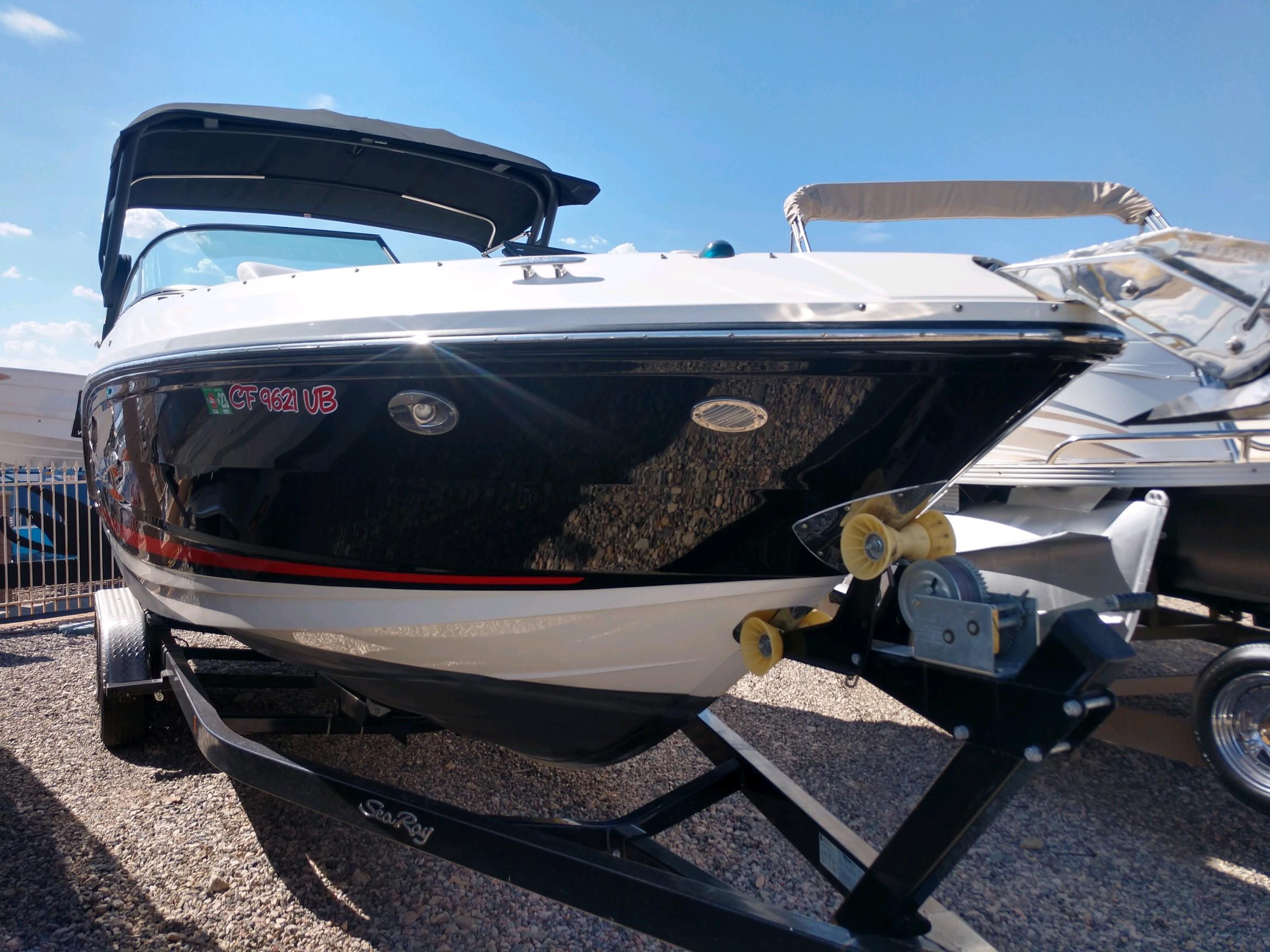 2018 Sea Ray SLX 280 boat on trailer under clear blue sky.
