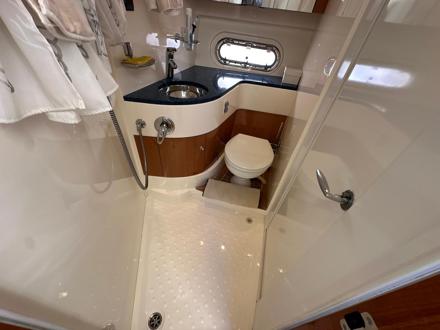 2007 Sealine F42/5 yacht bathroom with shower, sink, and toilet.