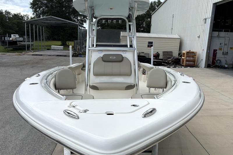 2024 Key West 239 FS boat, white exterior, docked near a warehouse.