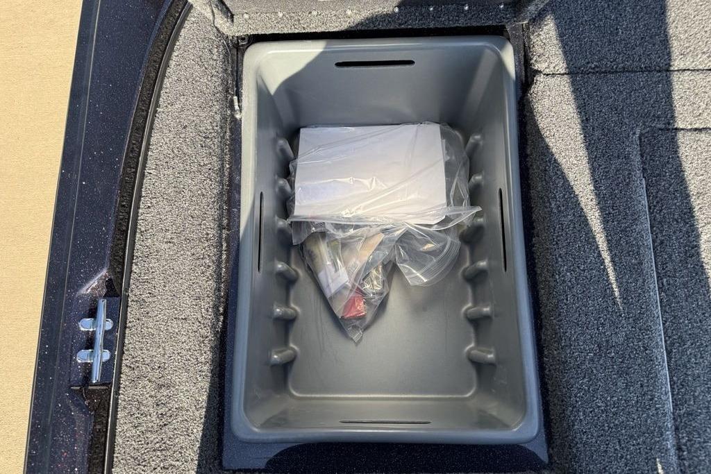 Storage compartment in a 2026 Nitro Z17 boat, containing packaged items.