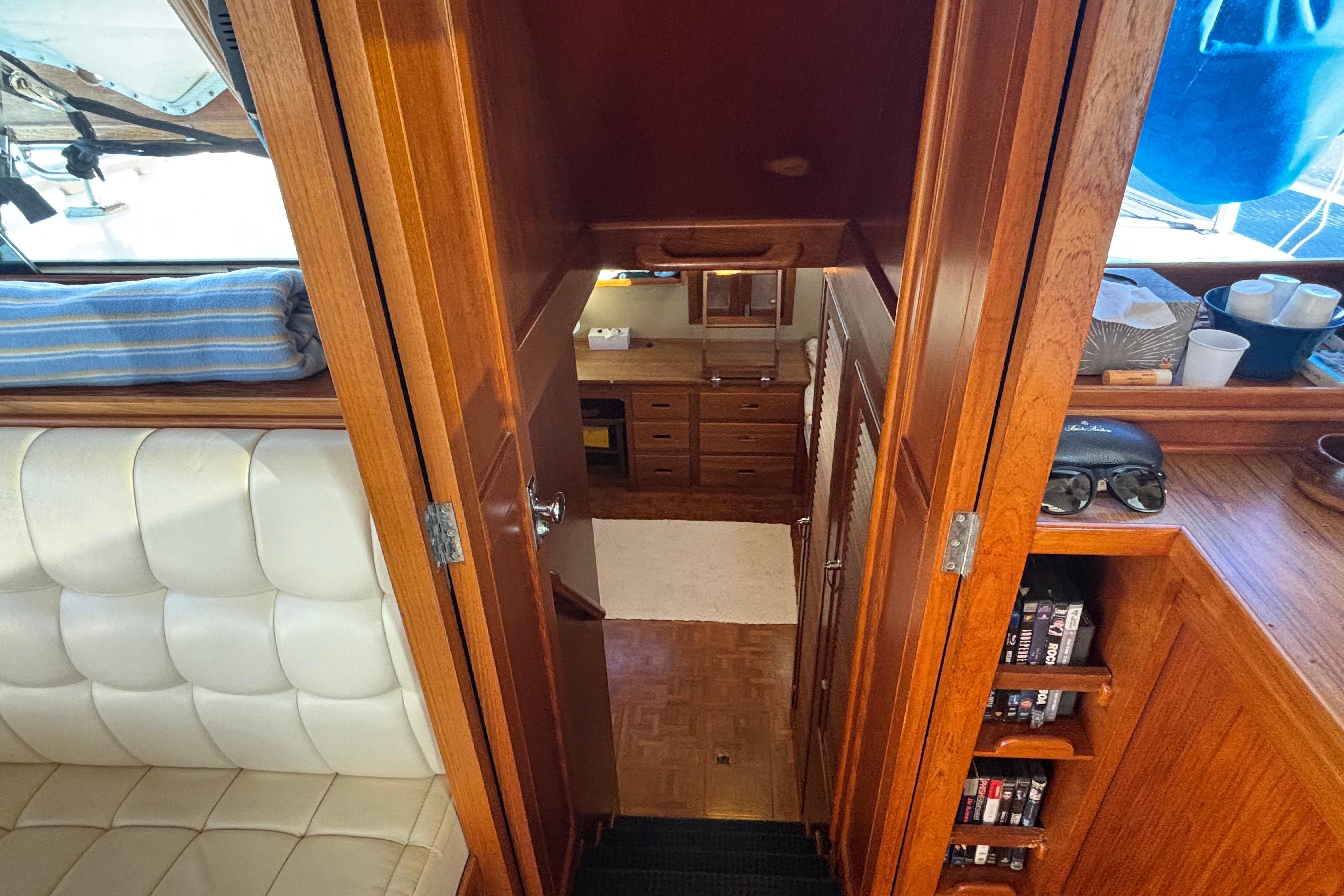 Interior view of 1989 Grand Banks 46 Classic yacht, featuring wooden cabinetry and seating.