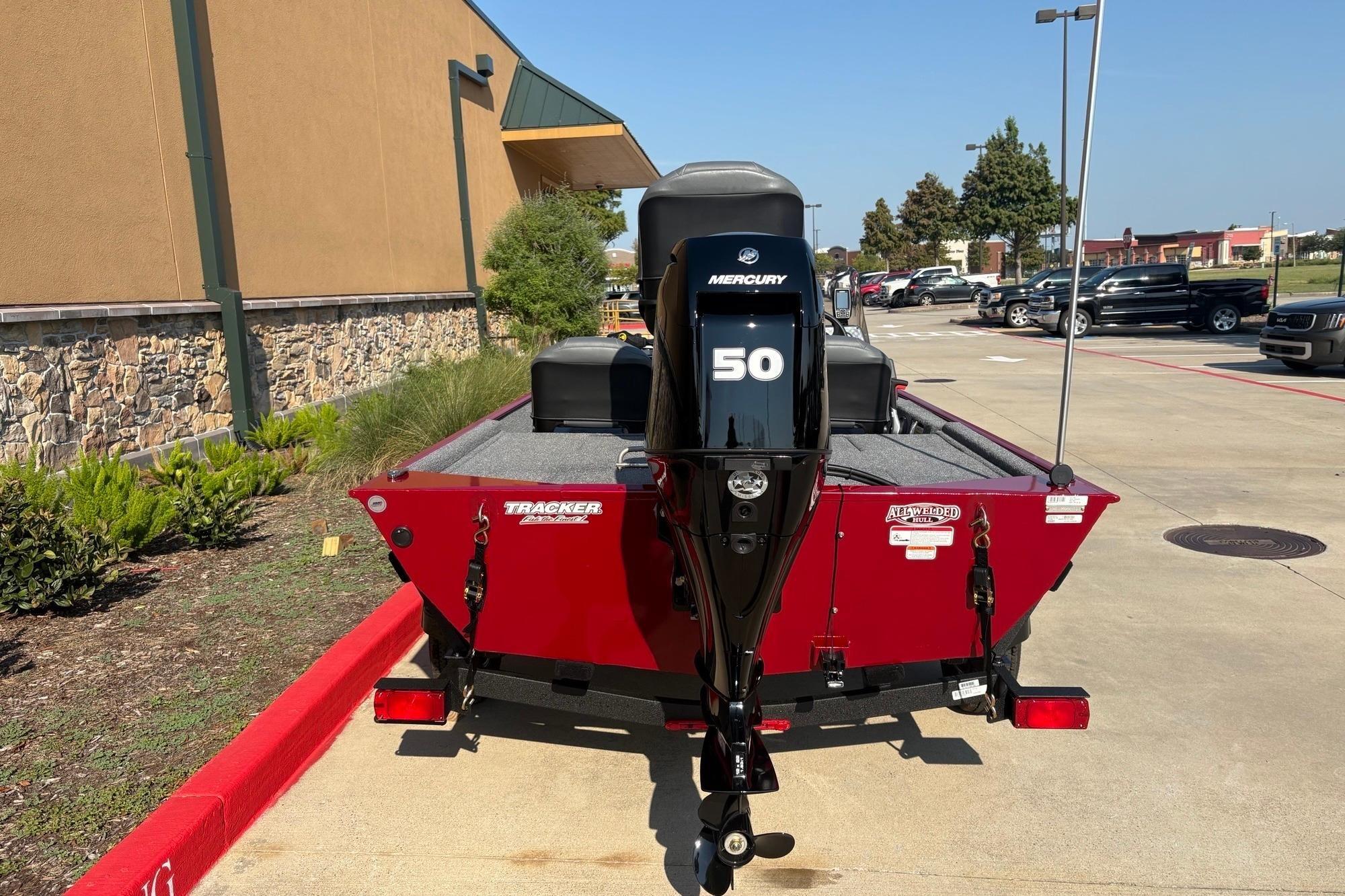 2026 Tracker Bass Tracker Classic XL boat with Mercury 50 engine in parking lot.