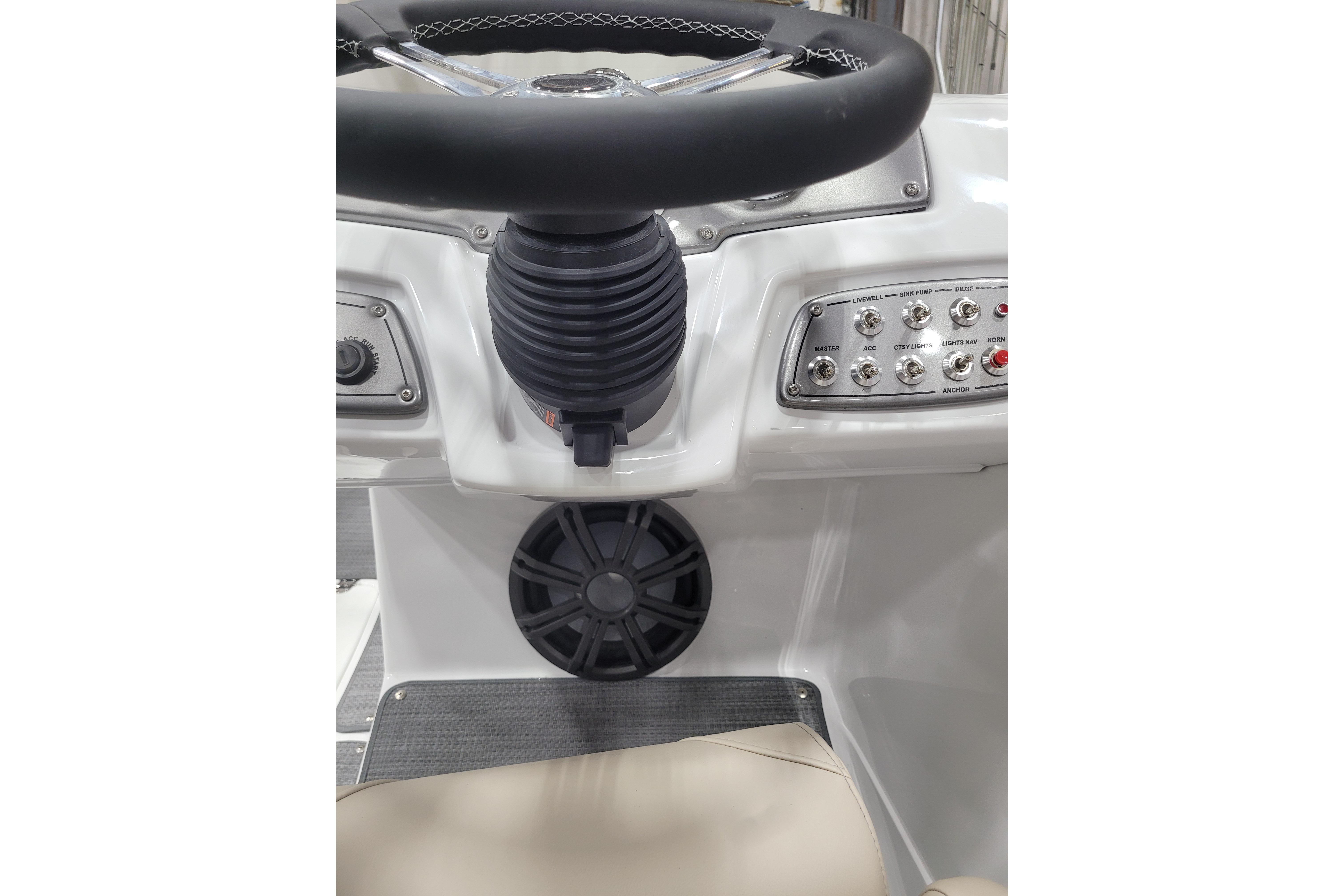 Steering console of 2026 Tahoe 2150 boat with control panel and speaker.