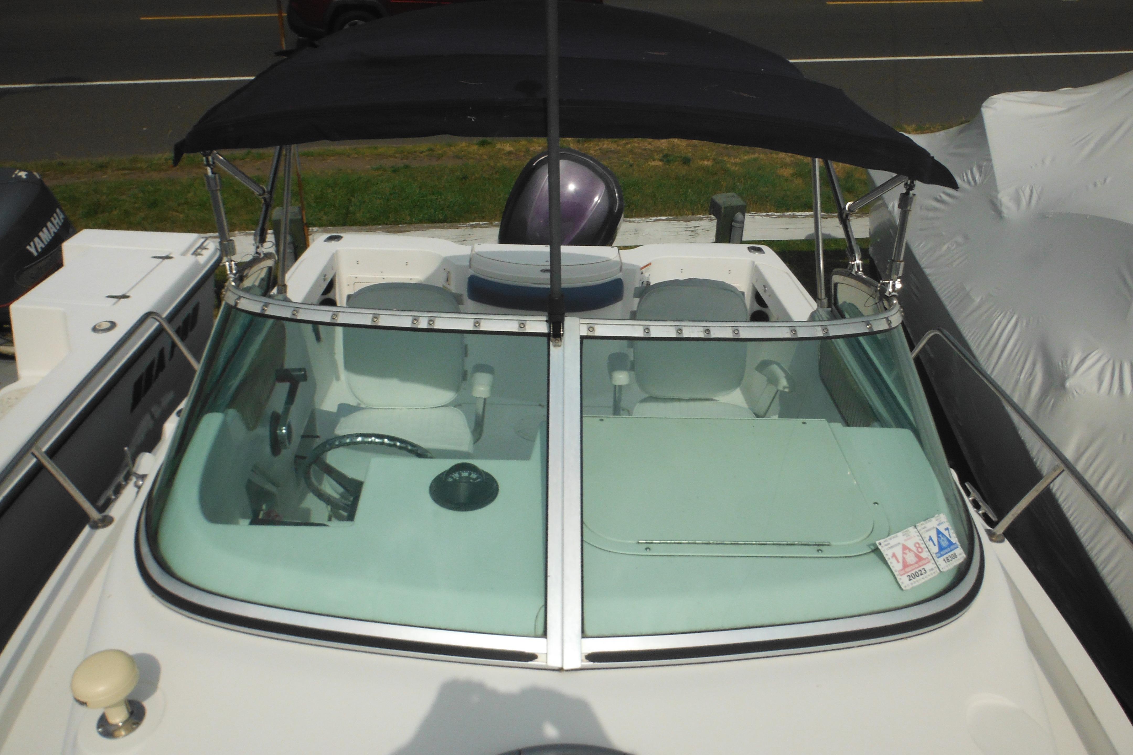 2005 Seaswirl Striper 2101 Walkaround O/B boat with windshield and black canopy.