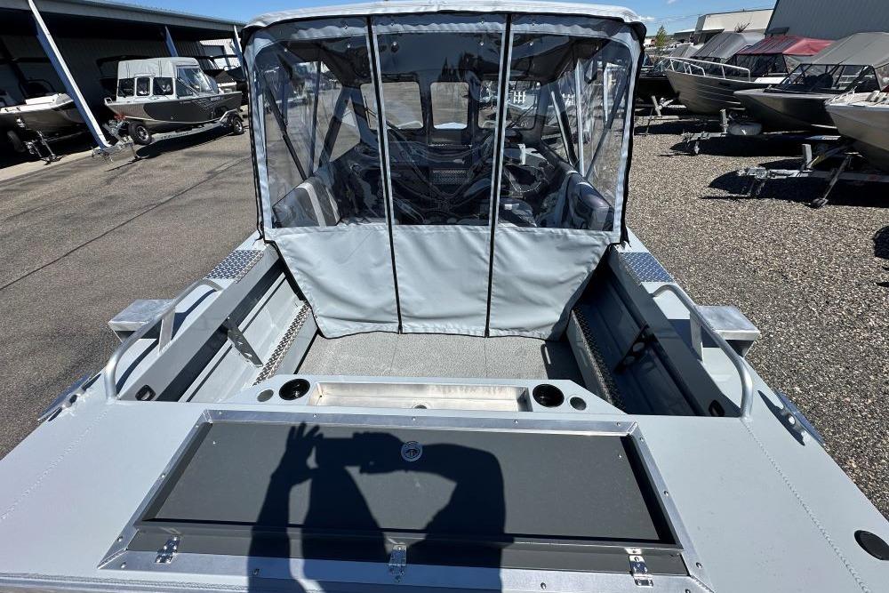 2026 Hewescraft 180 ProV ET boat with covered seating, docked outdoors.