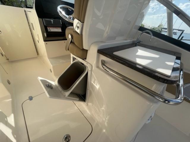 Interior of a 2019 Scout 255 Dorado boat with storage compartment.