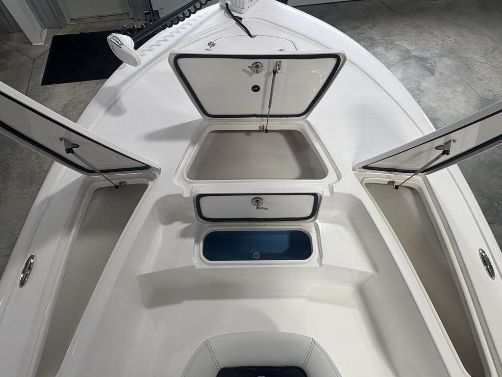 2026 Tidewater 2110 BM boat with open storage compartments and sleek white design.