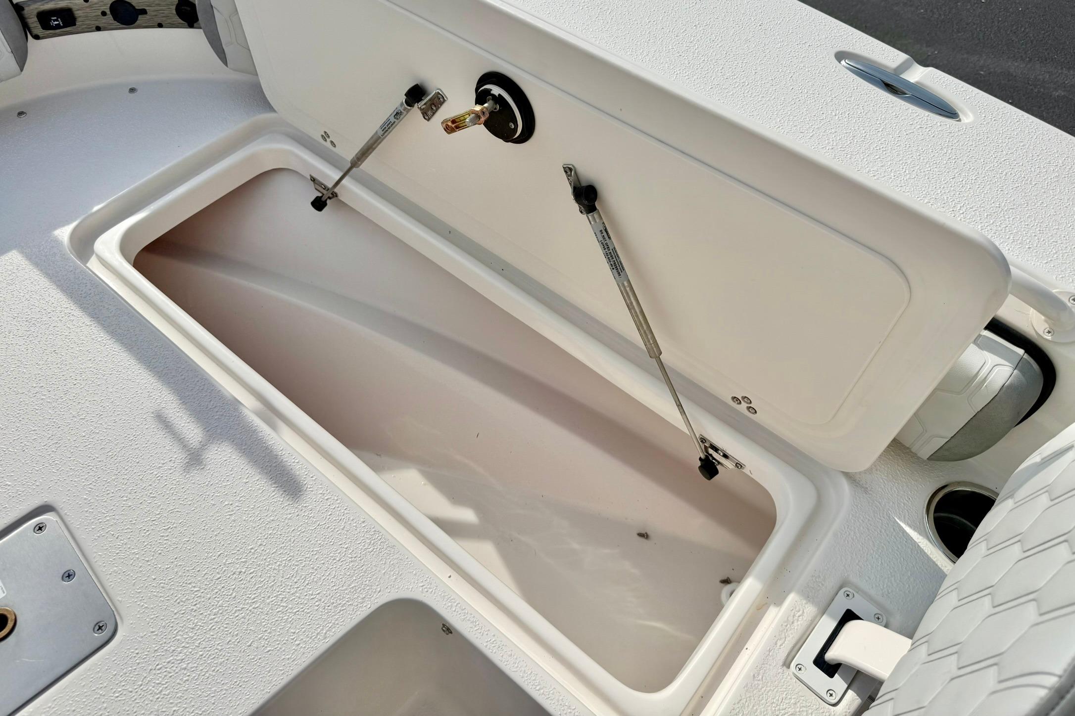 Open storage compartment on a 2026 Carolina Skiff 24 Ultra Elite boat.