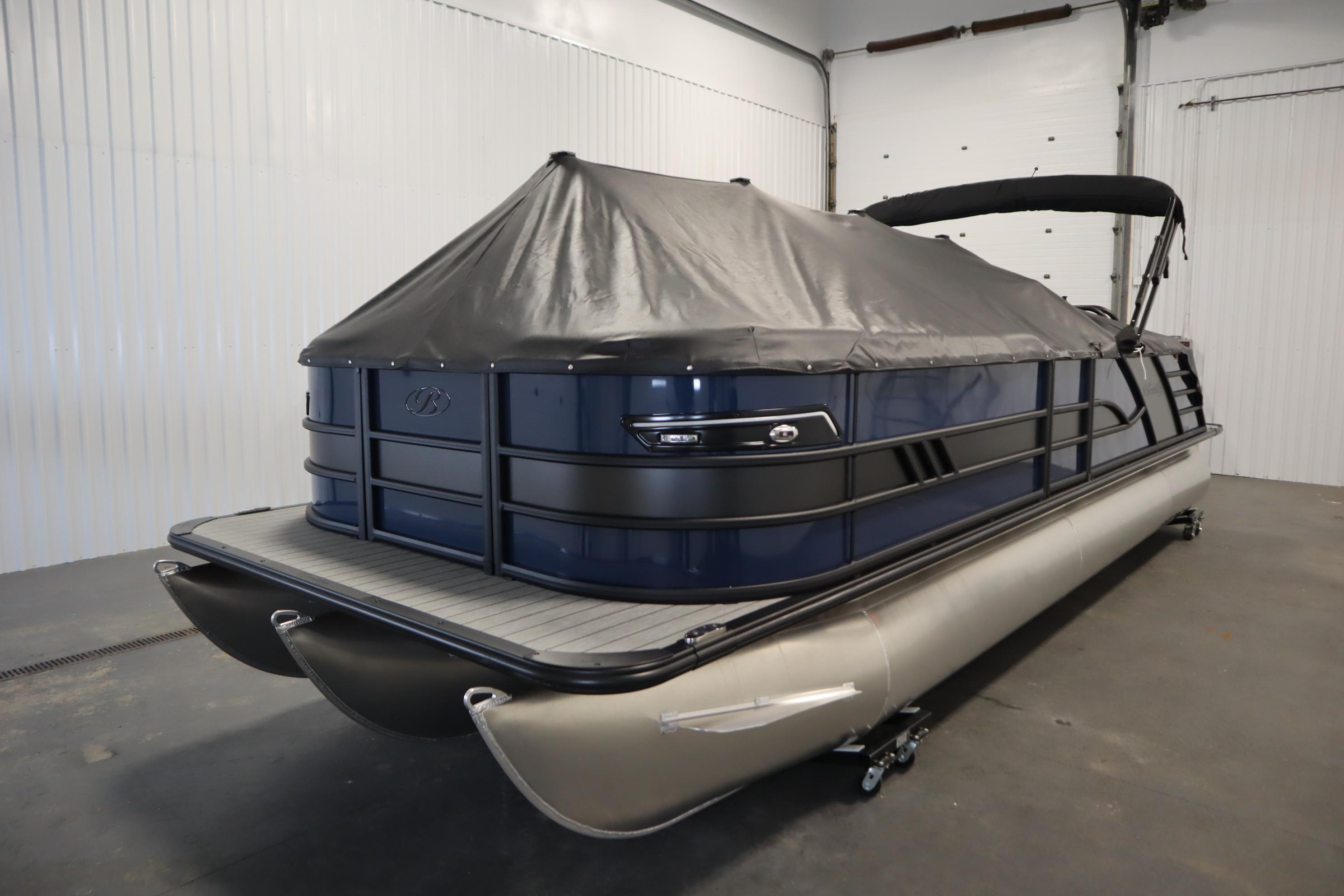 2025 Bentley Pontoons Elite 253 Admiral Tri-toon with cover in a garage setting.