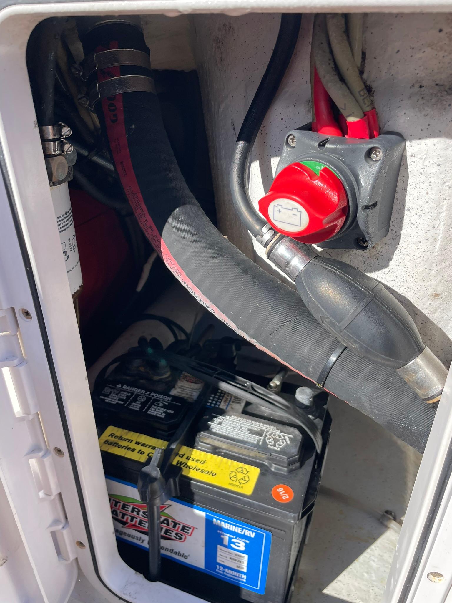 Battery compartment of a 2001 Protector Targa 28 boat with wiring and switch.