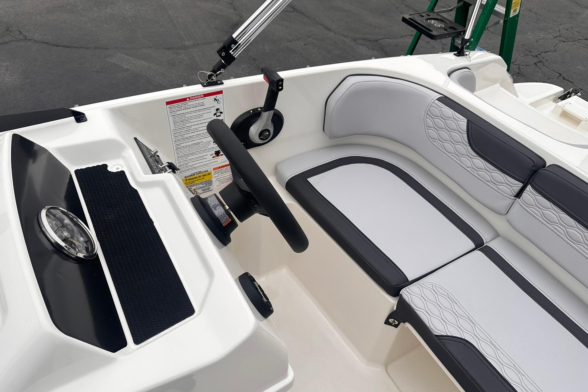 2026 Bayliner M17 boat interior with steering wheel and cushioned seating.