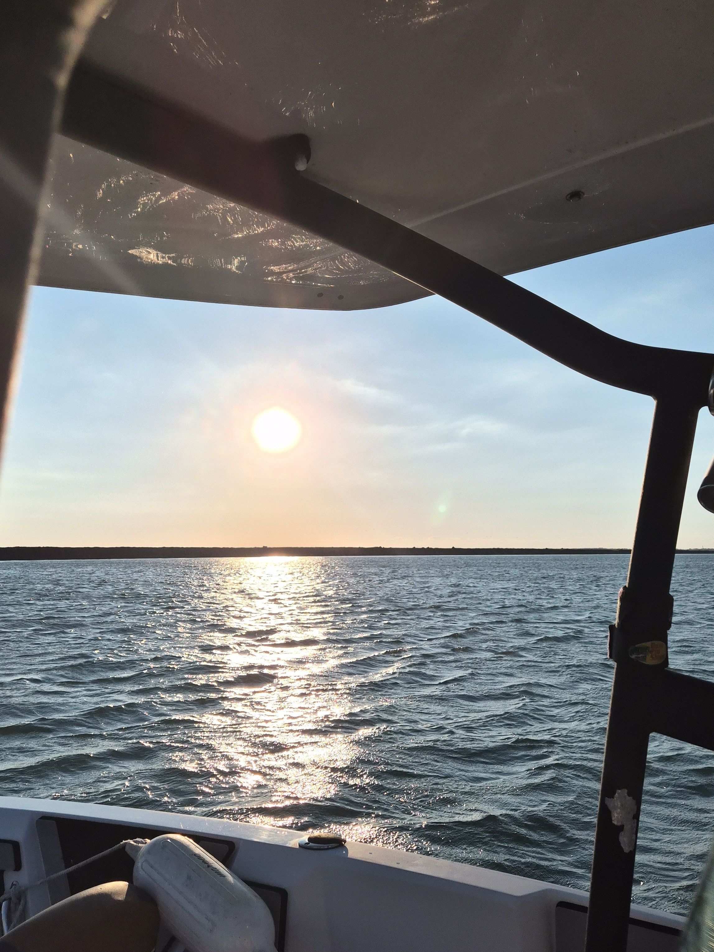 Sunset over water from a Scarab 255 Open ID boat.