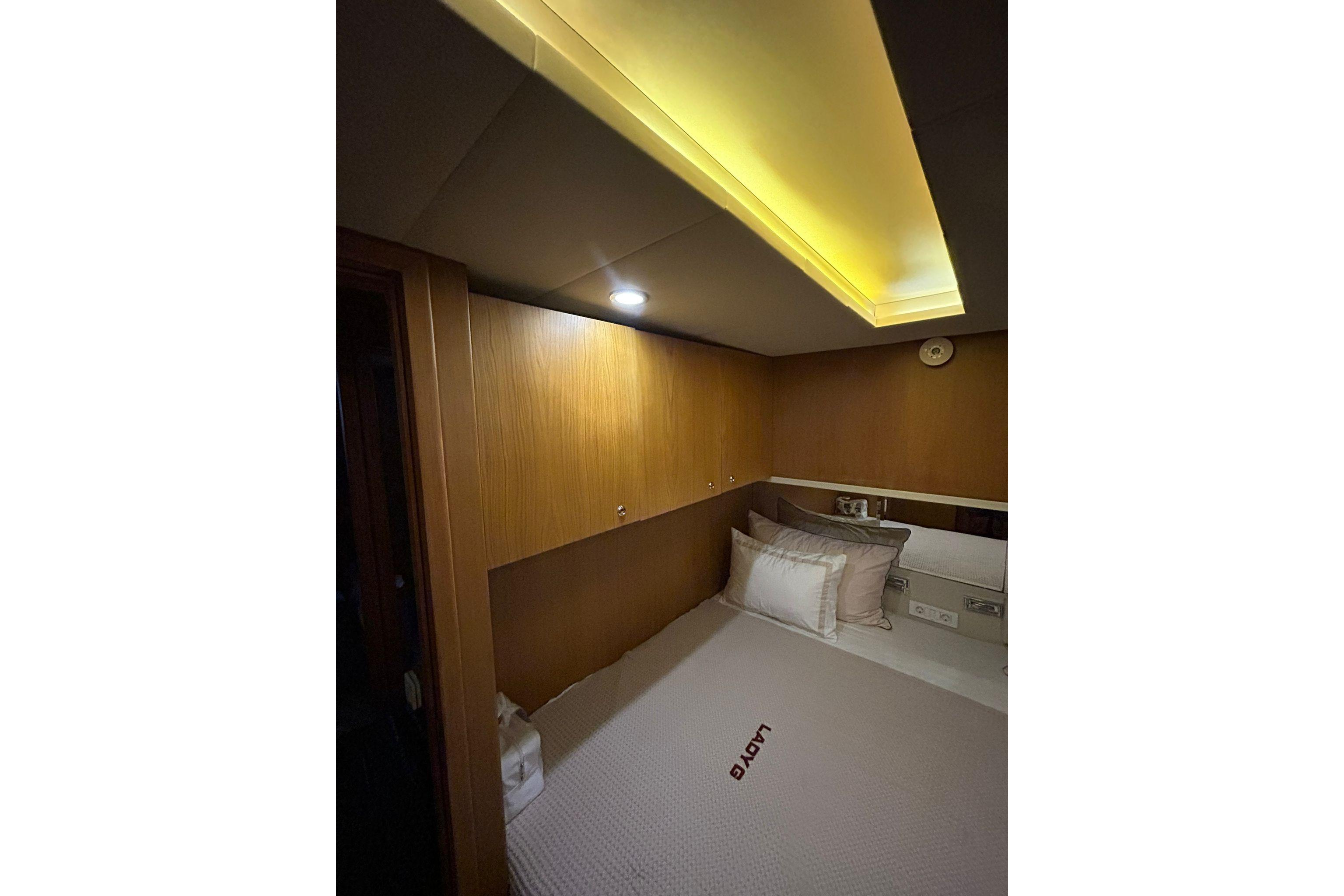 Cozy cabin interior with wooden paneling and soft lighting, Custom 68 model, 2009.