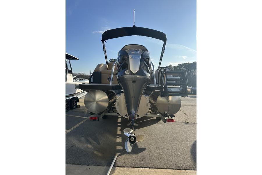 2026 Evotti 523CS boat with outboard motor and canopy, parked on pavement.