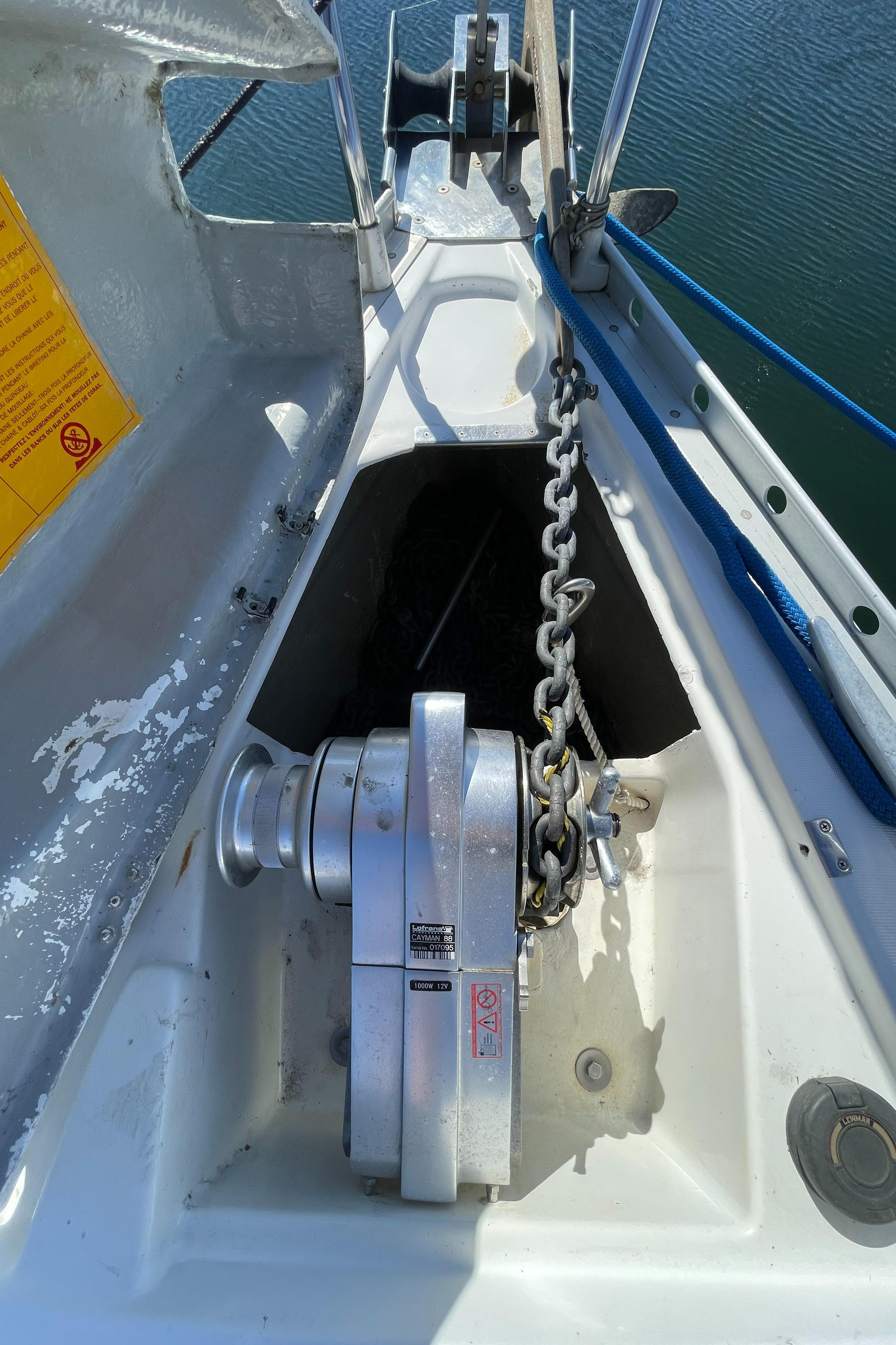 Anchor windlass on a 1994 Beneteau 352 sailboat, with chain and water view.
