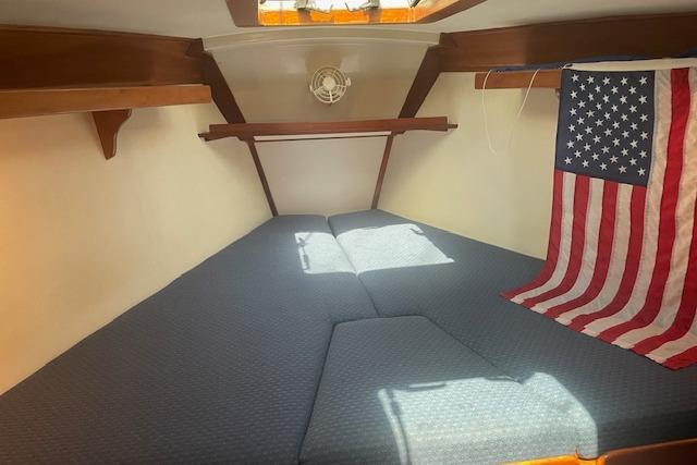 Cozy cabin interior of 2001 Tartan 3700 sailboat with American flag decor.