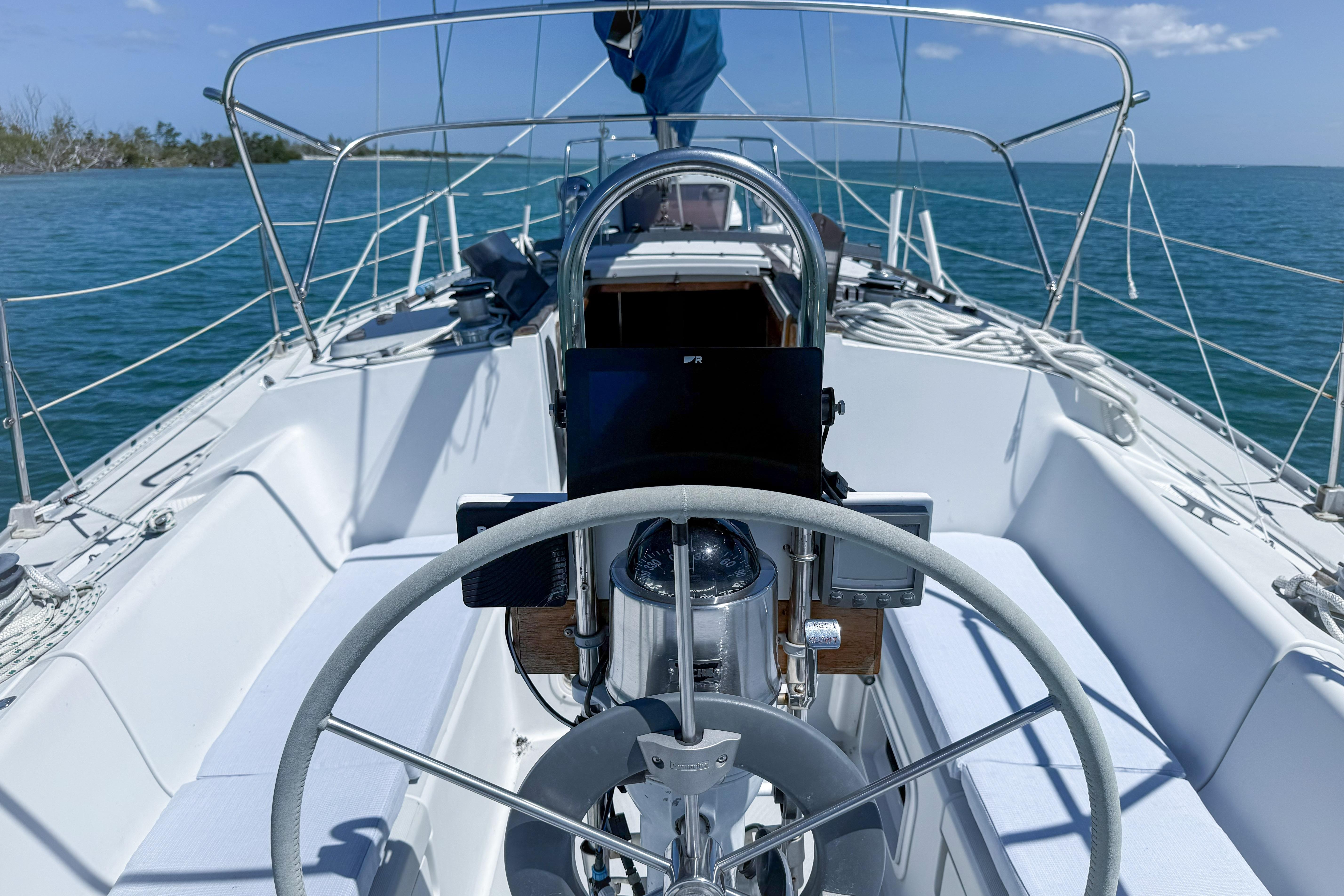 Cockpit view of a 1988 Oday 40 sailboat on calm blue waters.