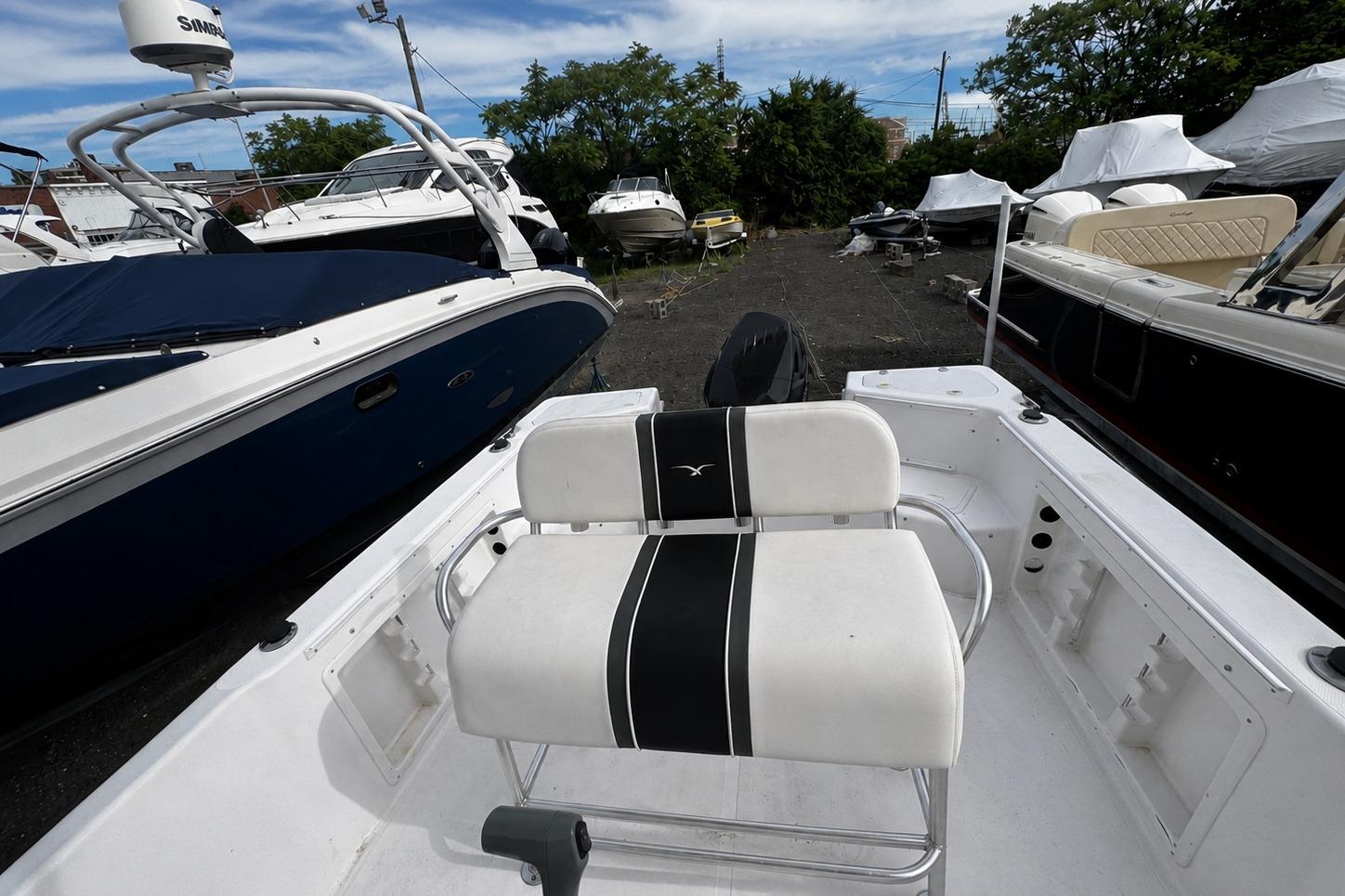 2008 PROLINE 20 Sport boat with white seating, parked among other boats.