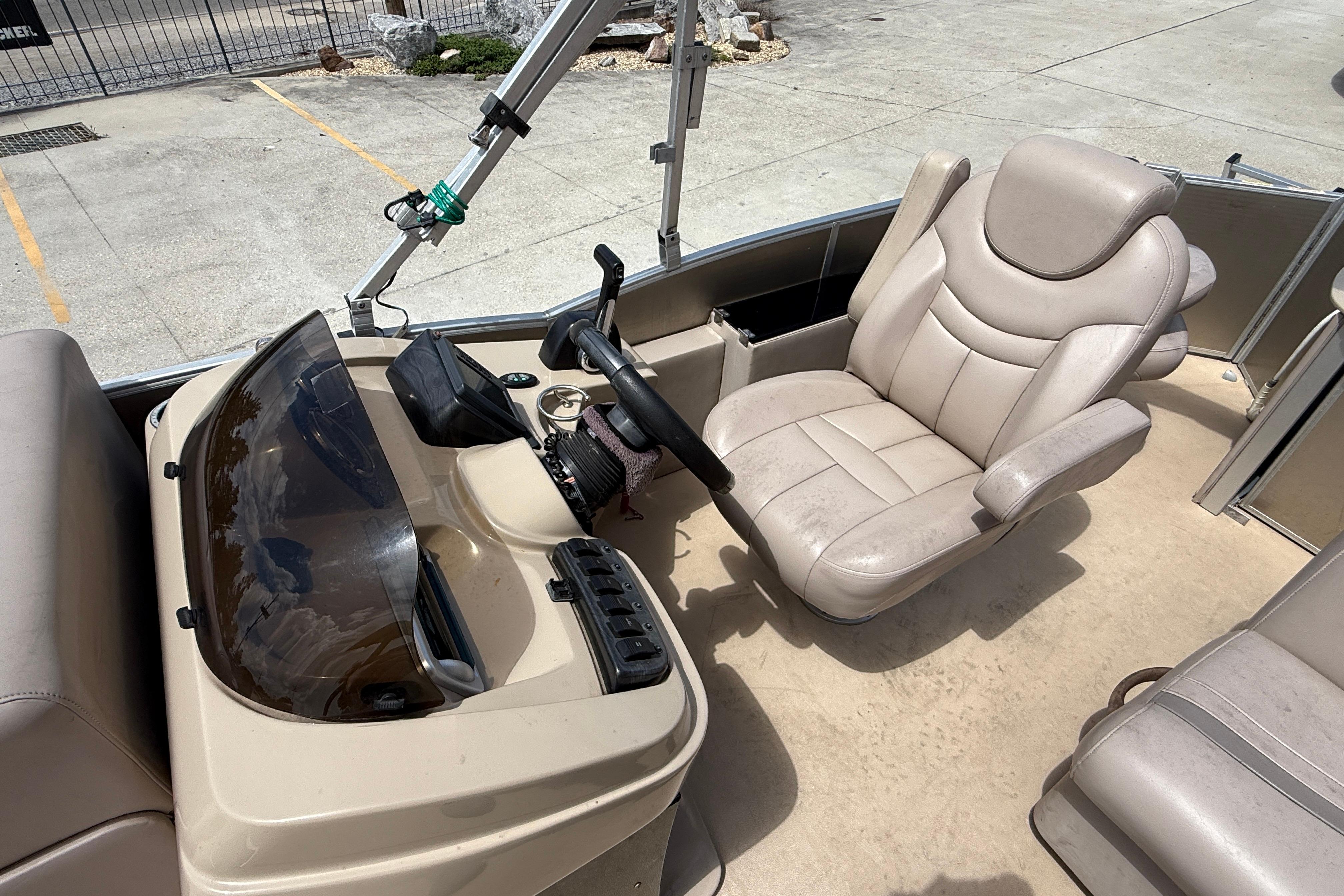 2014 Godfrey Sweetwater 2486 C boat interior with steering console and captain's chair.