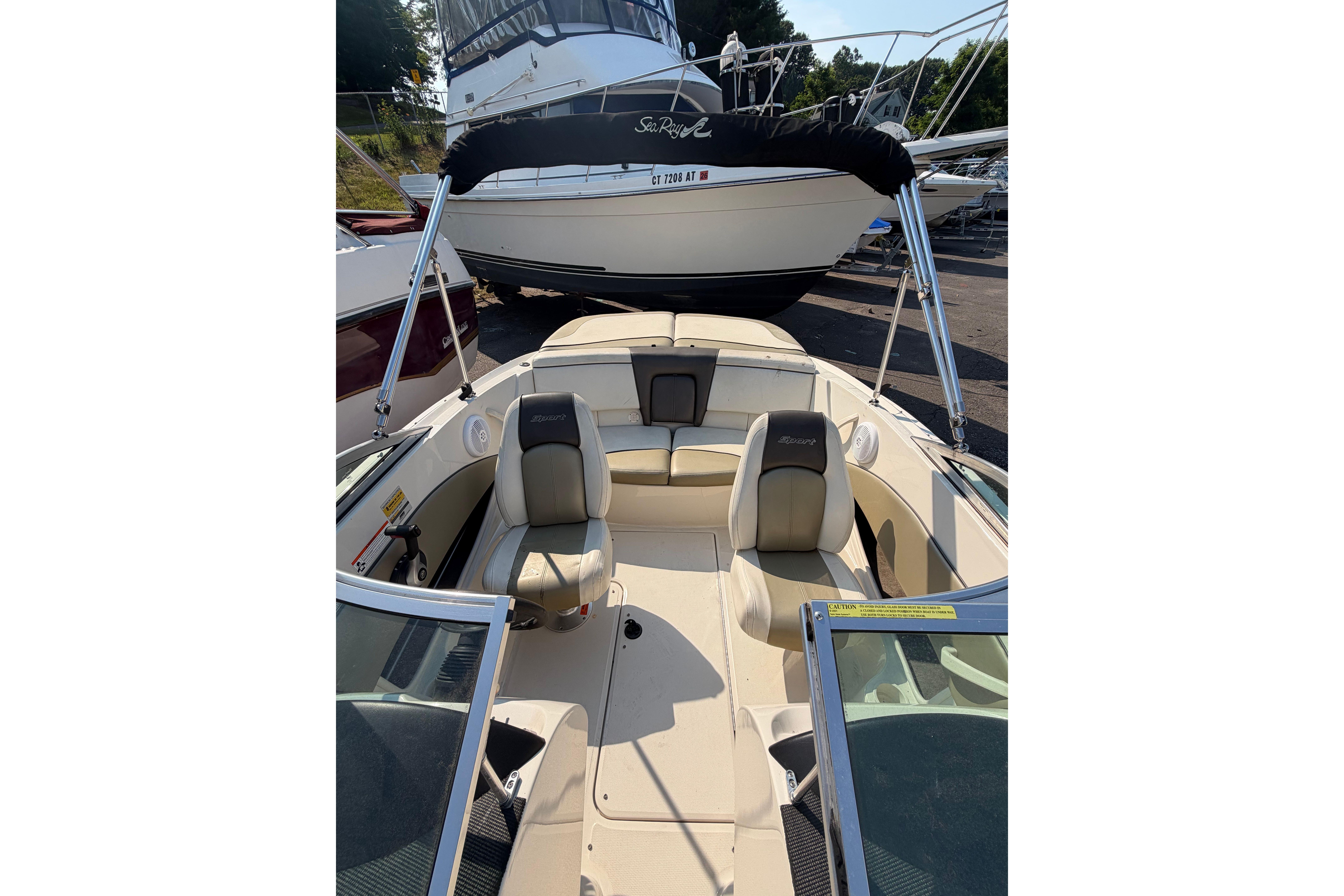 2006 Sea Ray 195 Sport boat interior with seating and steering wheel, parked in marina.