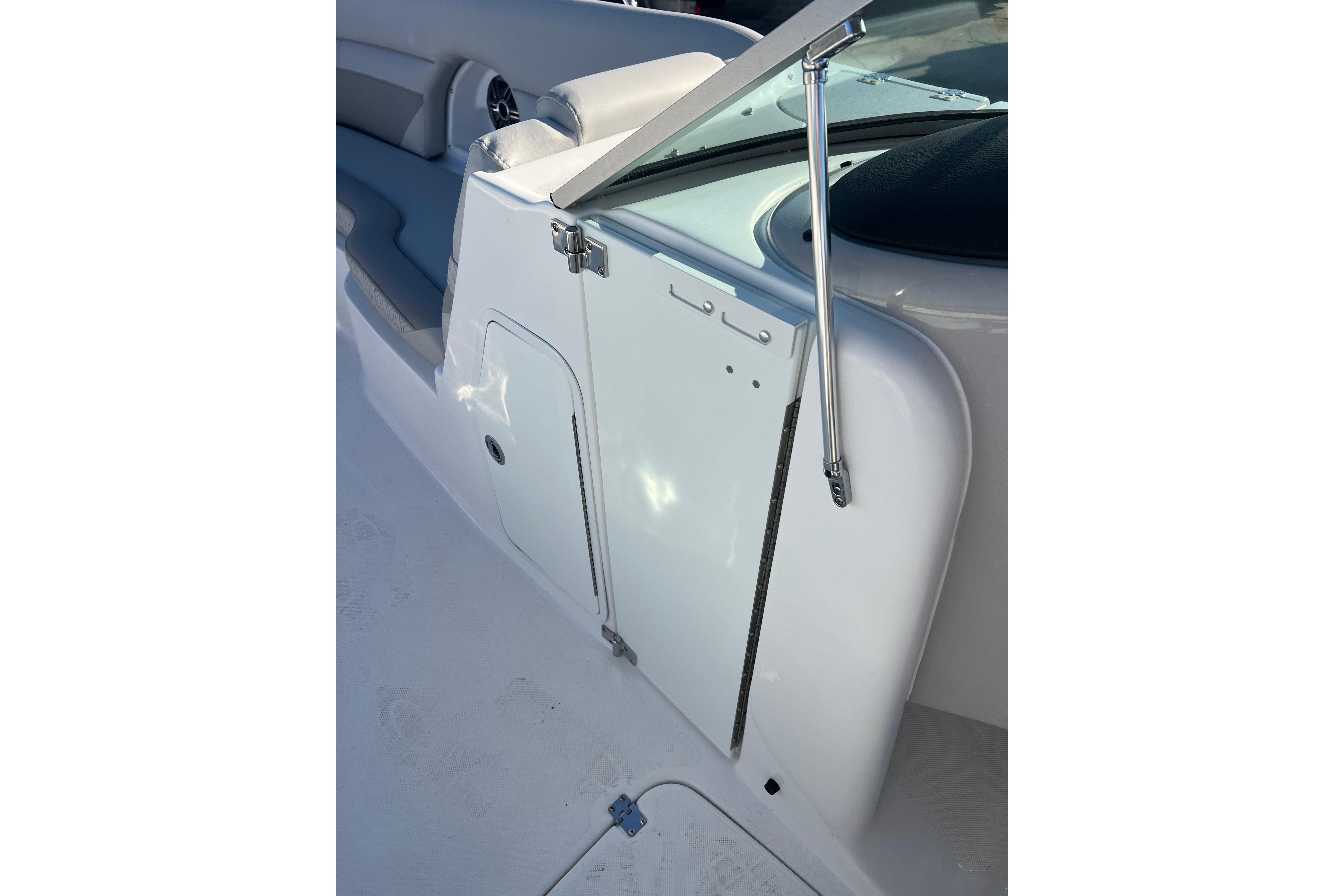 2026 Hurricane SunDeck 2486 OB boat interior with seating and storage compartment.