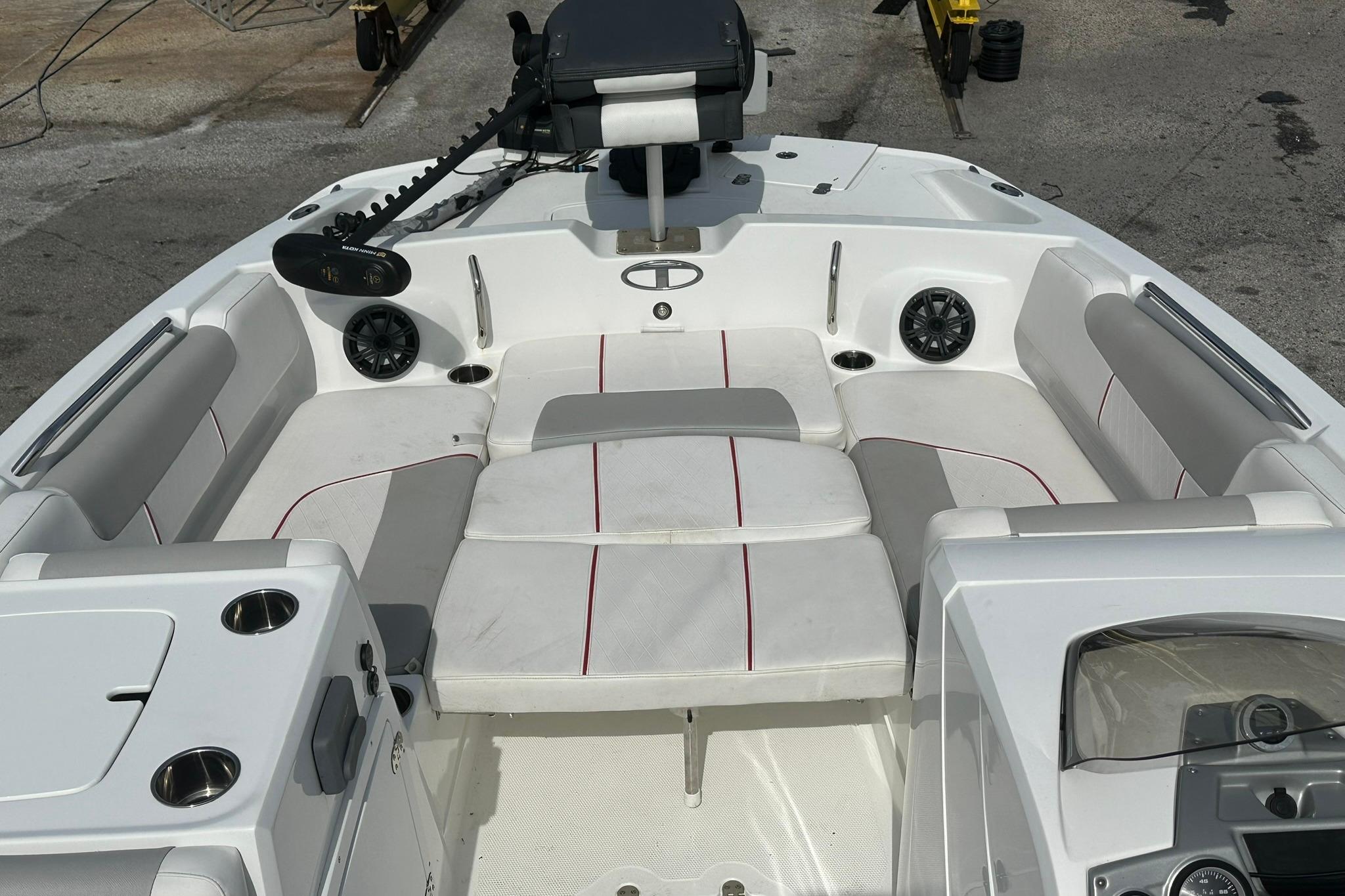 2021 Tahoe 2150 boat interior with white and gray seating, cup holders, and speakers.