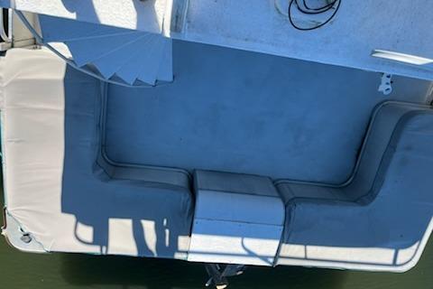 Overhead view of a 1994 PlayCraft 5215 boat deck with seating and shadows.