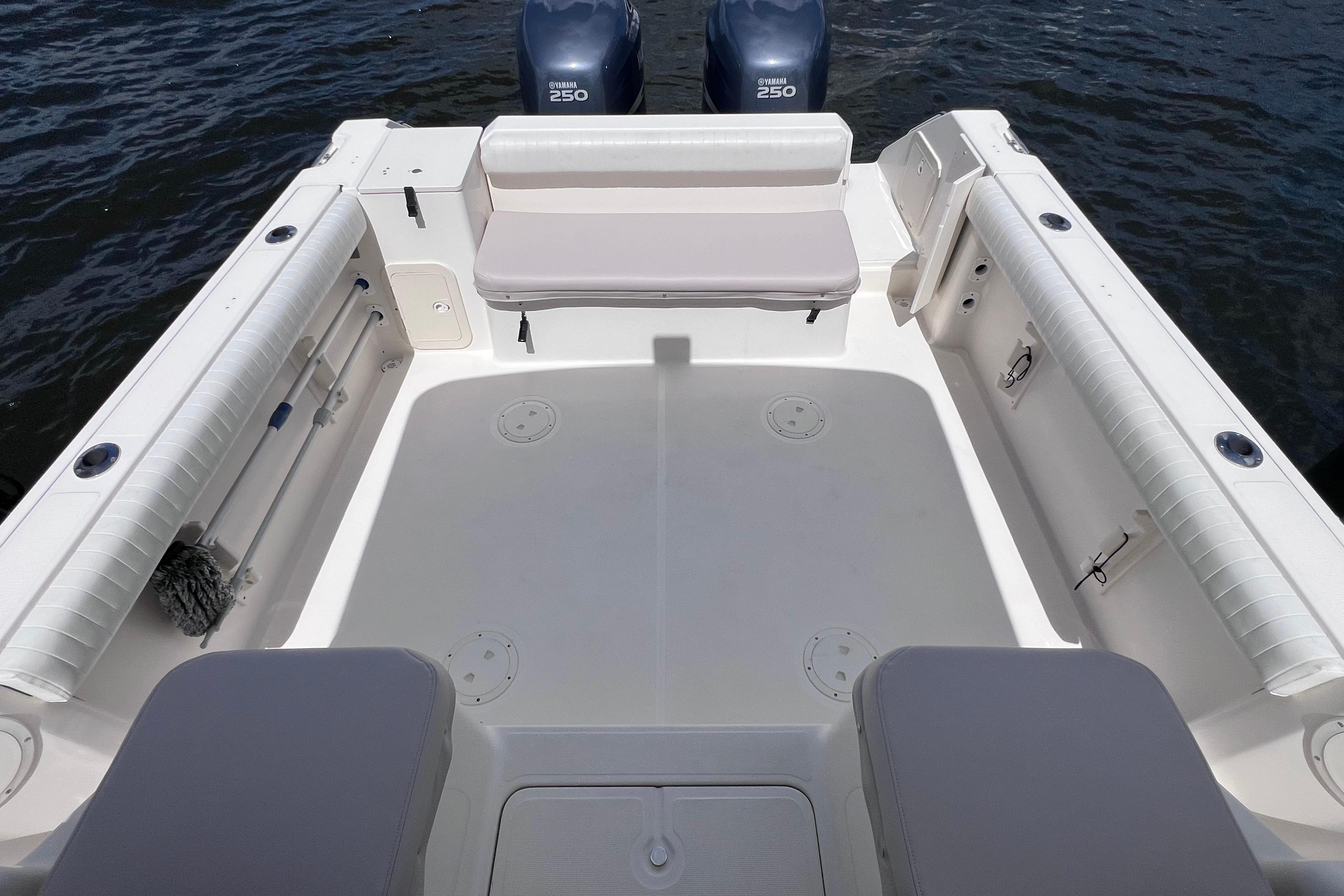 2004 Pursuit 2870 Walkaround boat deck with seating and twin Yamaha 250 engines.