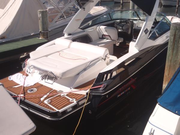 2015 Monterey 288 Super Sport boat docked, featuring sleek design and spacious seating.