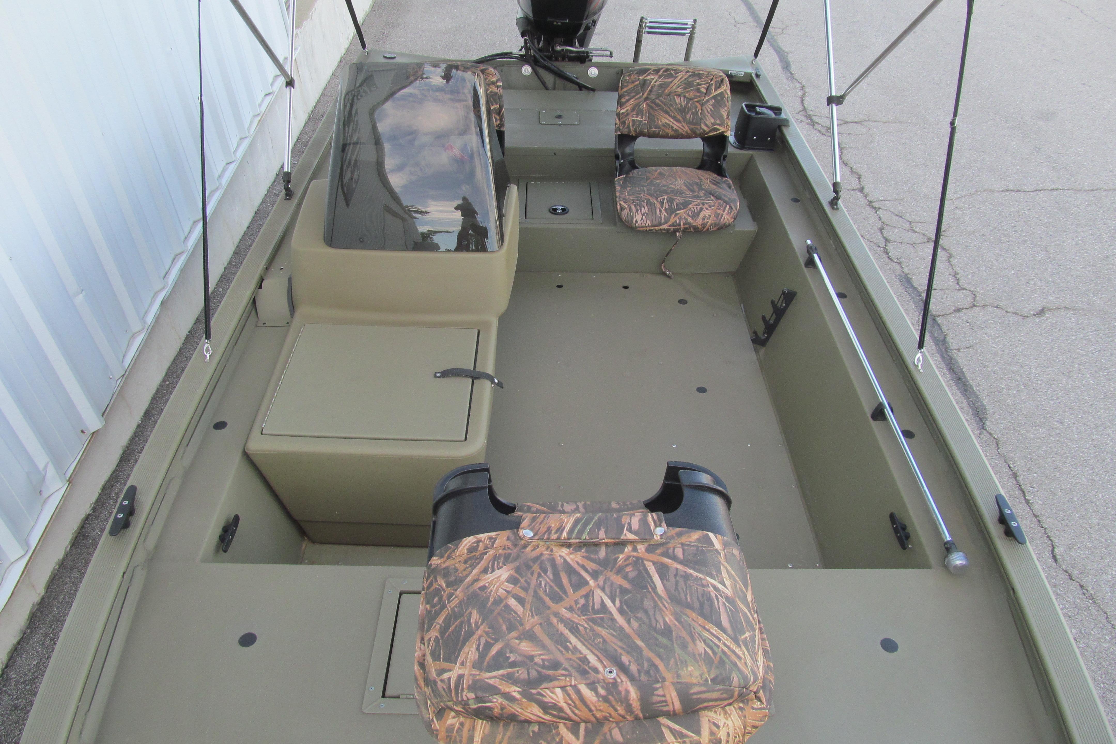 2018 Tracker Grizzly 1754 SC boat interior with camouflage seating and storage compartments.