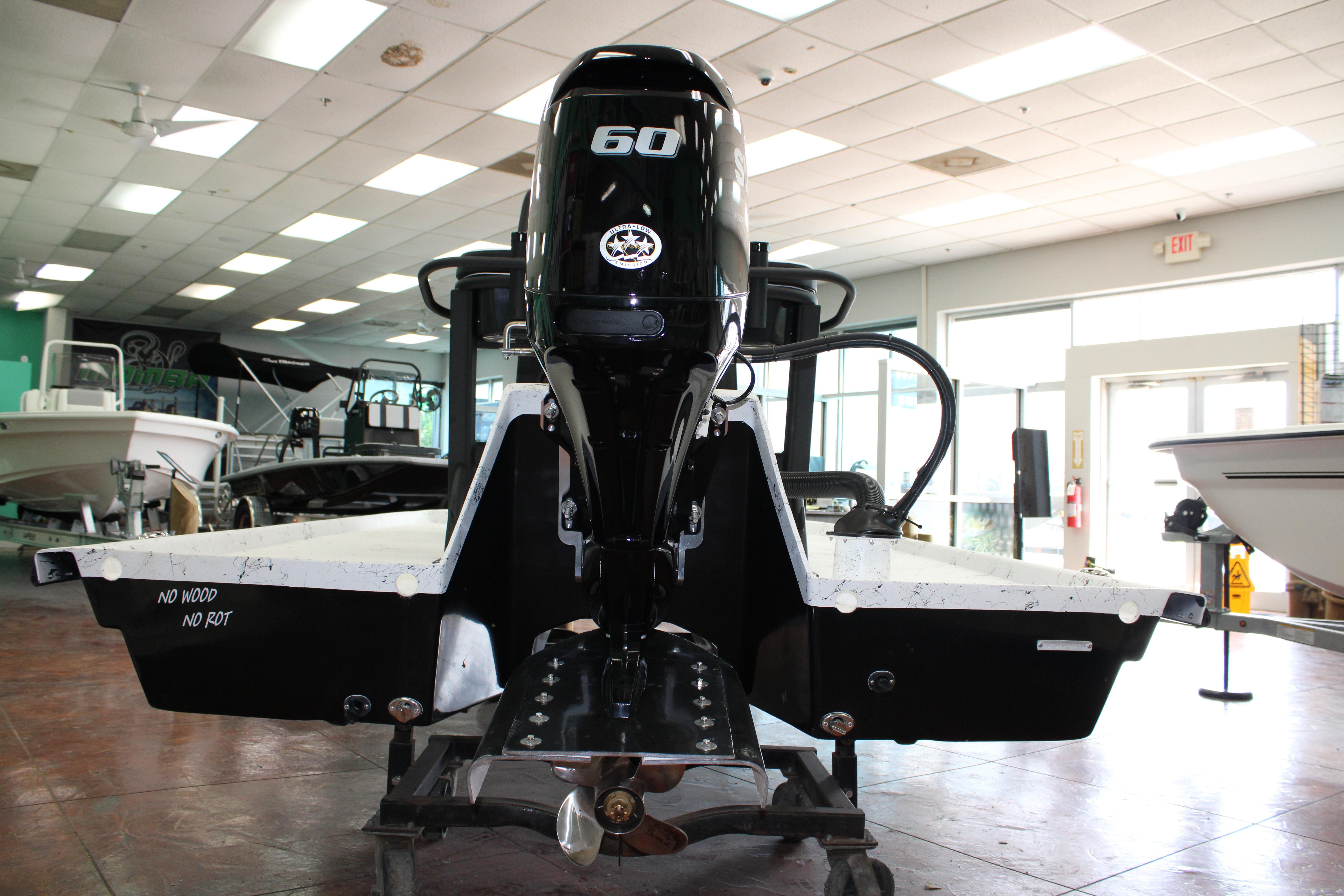 2026 Freedom Boats Chiquita with 60 HP engine displayed indoors.