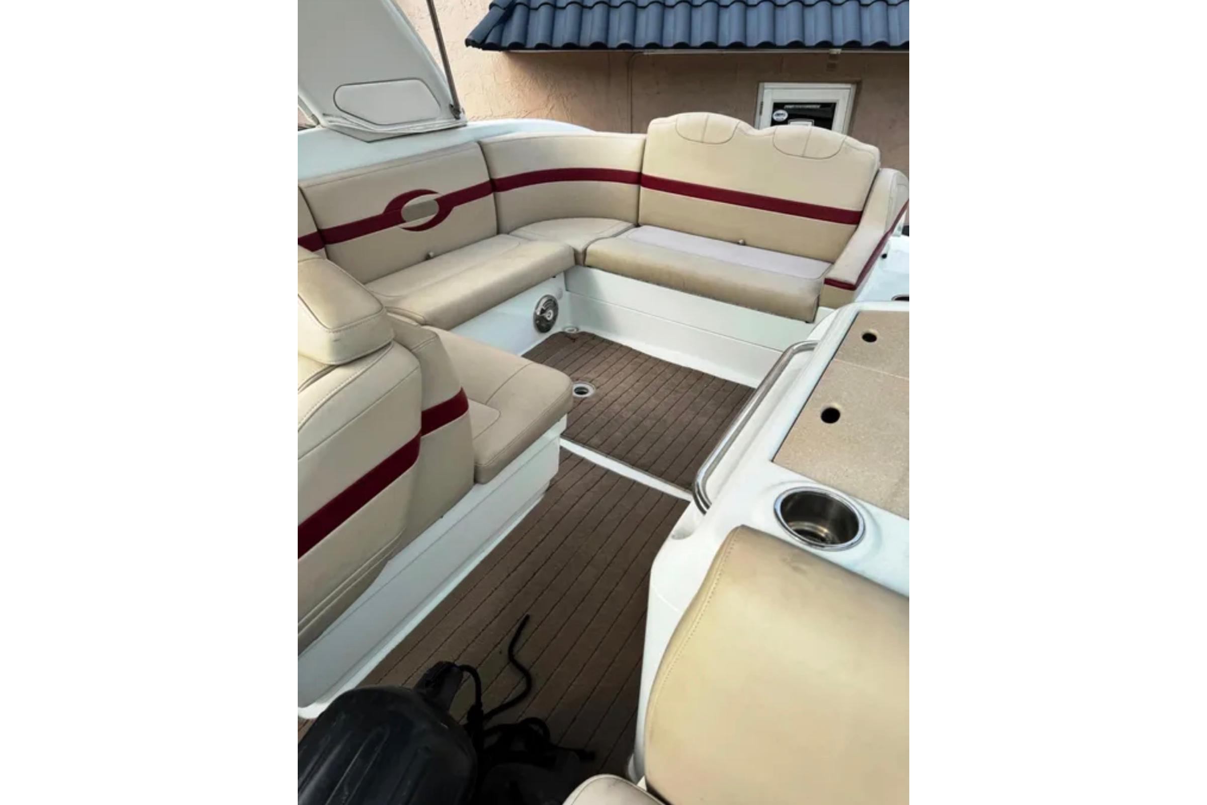 2010 Formula 310 Sun Sport boat interior with beige seating and wood flooring.