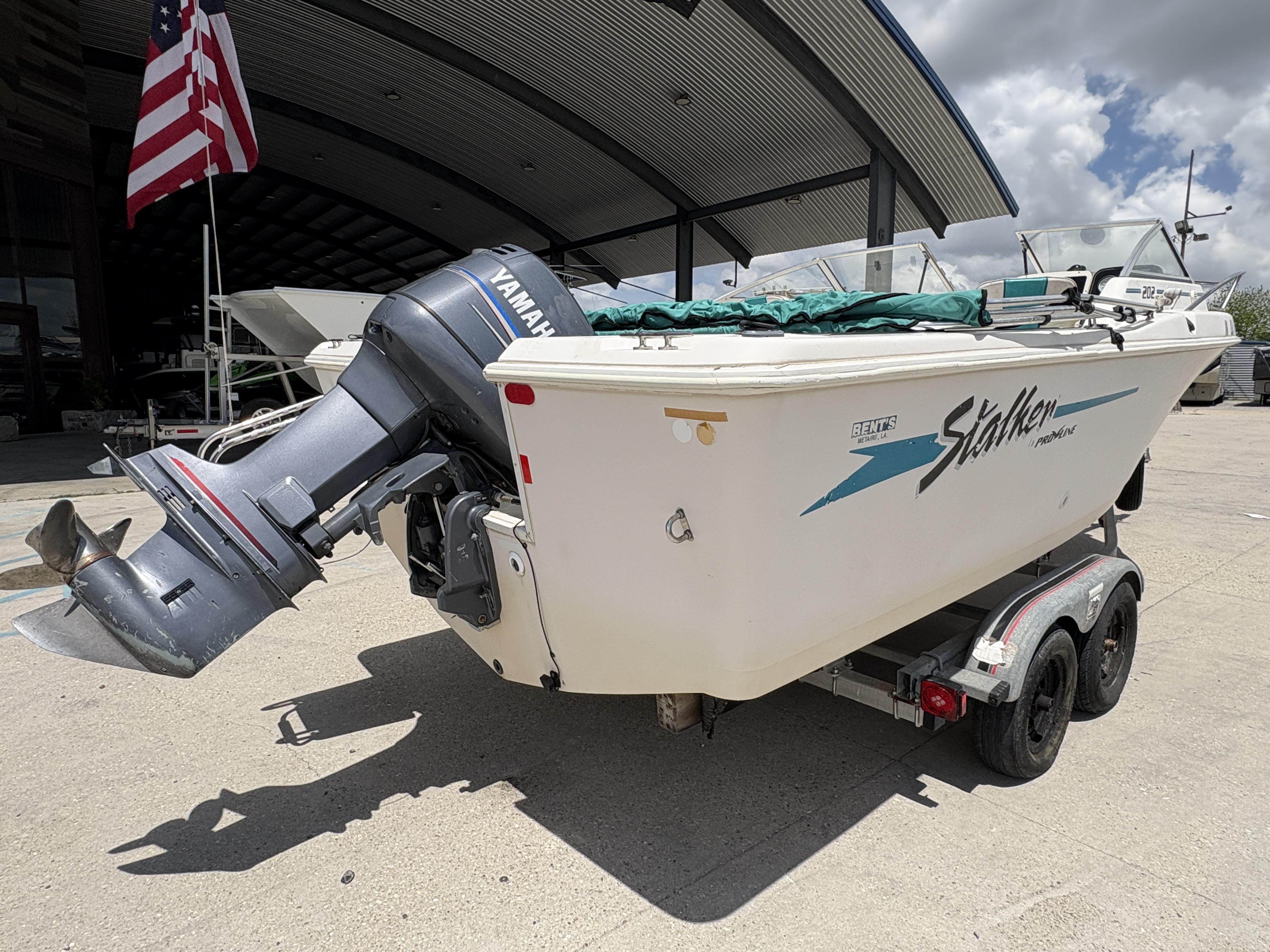 1996 Pro-Line 202 boat with Yamaha outboard motor on trailer, parked outdoors.