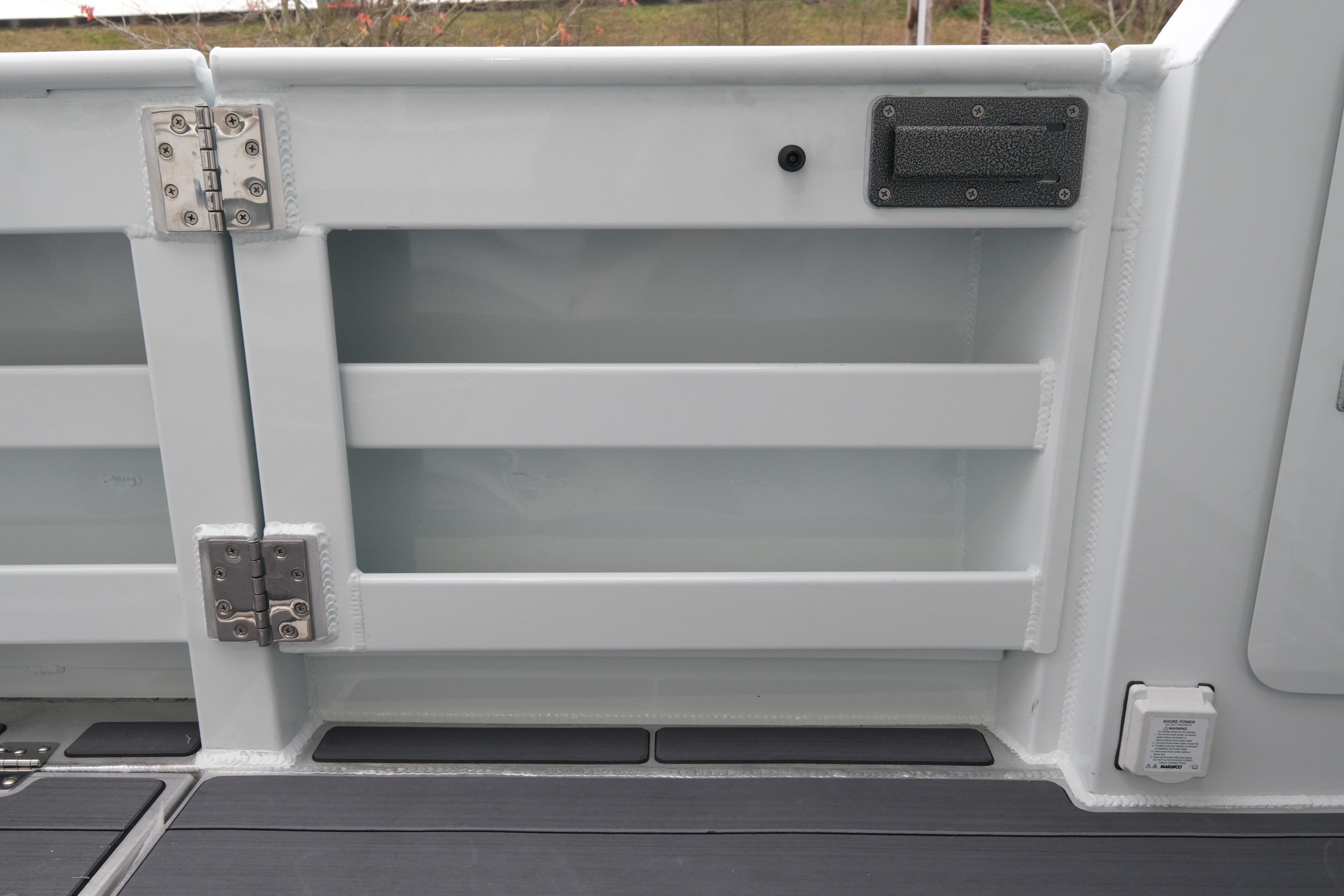 2026 Hewescraft 270 Pacific Explorer boat interior detail with storage compartment and hinges.