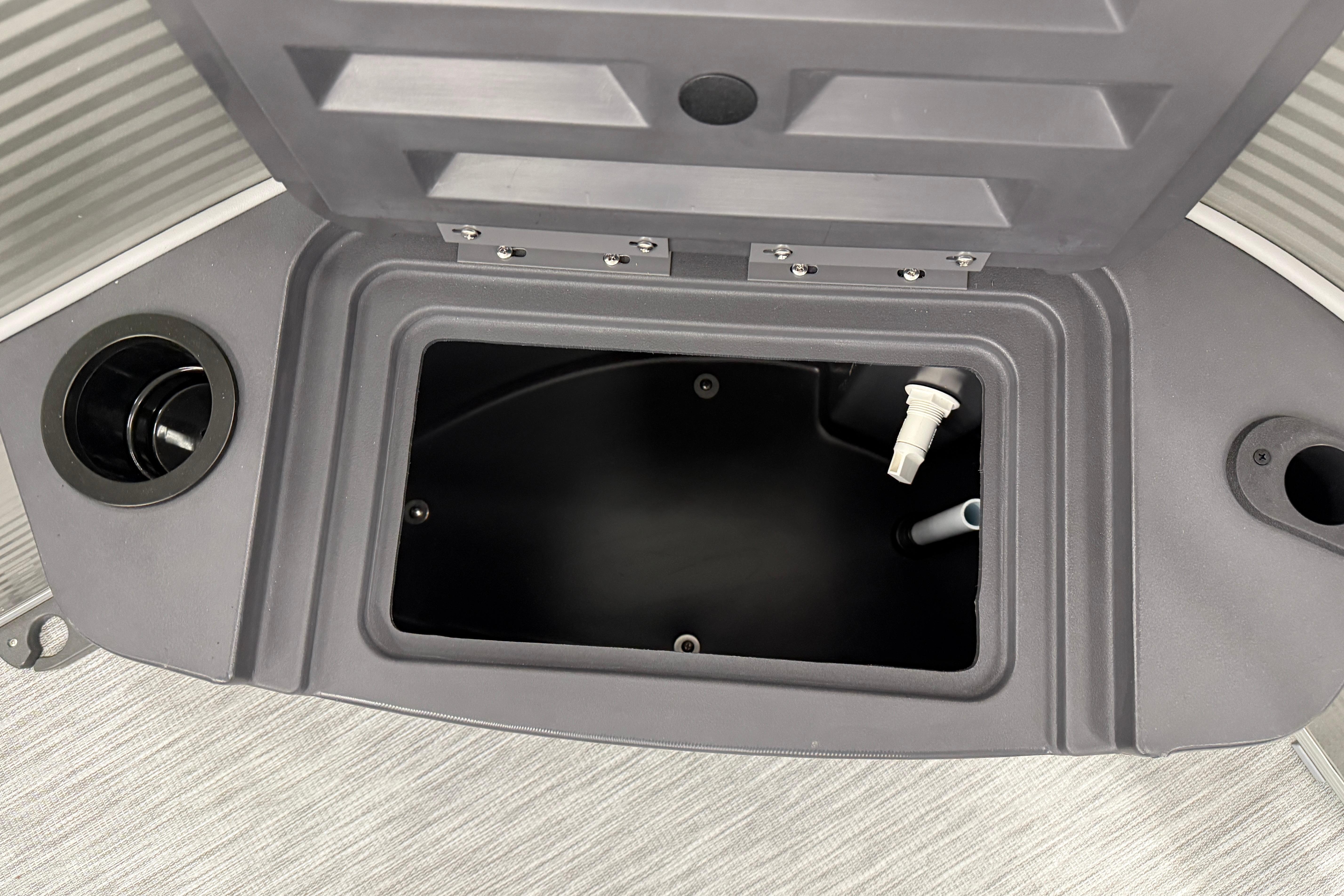 Open storage compartment on a 2026 Bennington 20 SF boat, featuring a sleek design.