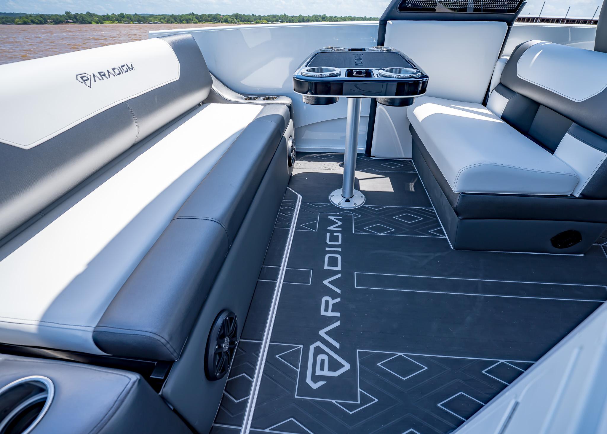 Luxurious interior of 2025 Paradigm Damascus 266 Surf boat with stylish seating and table.