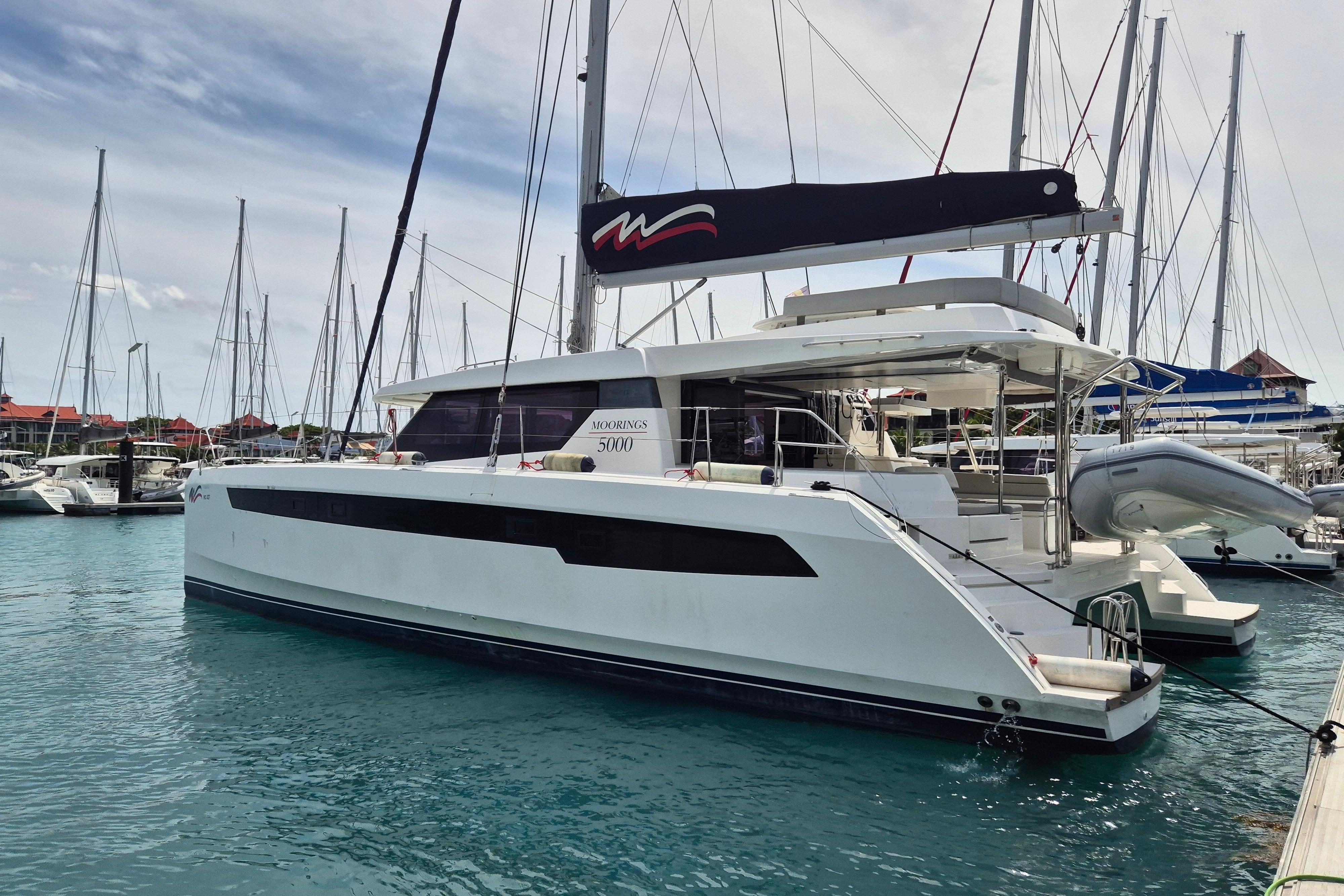 2021 Leopard 50 catamaran docked in a marina, showcasing sleek design and modern features.