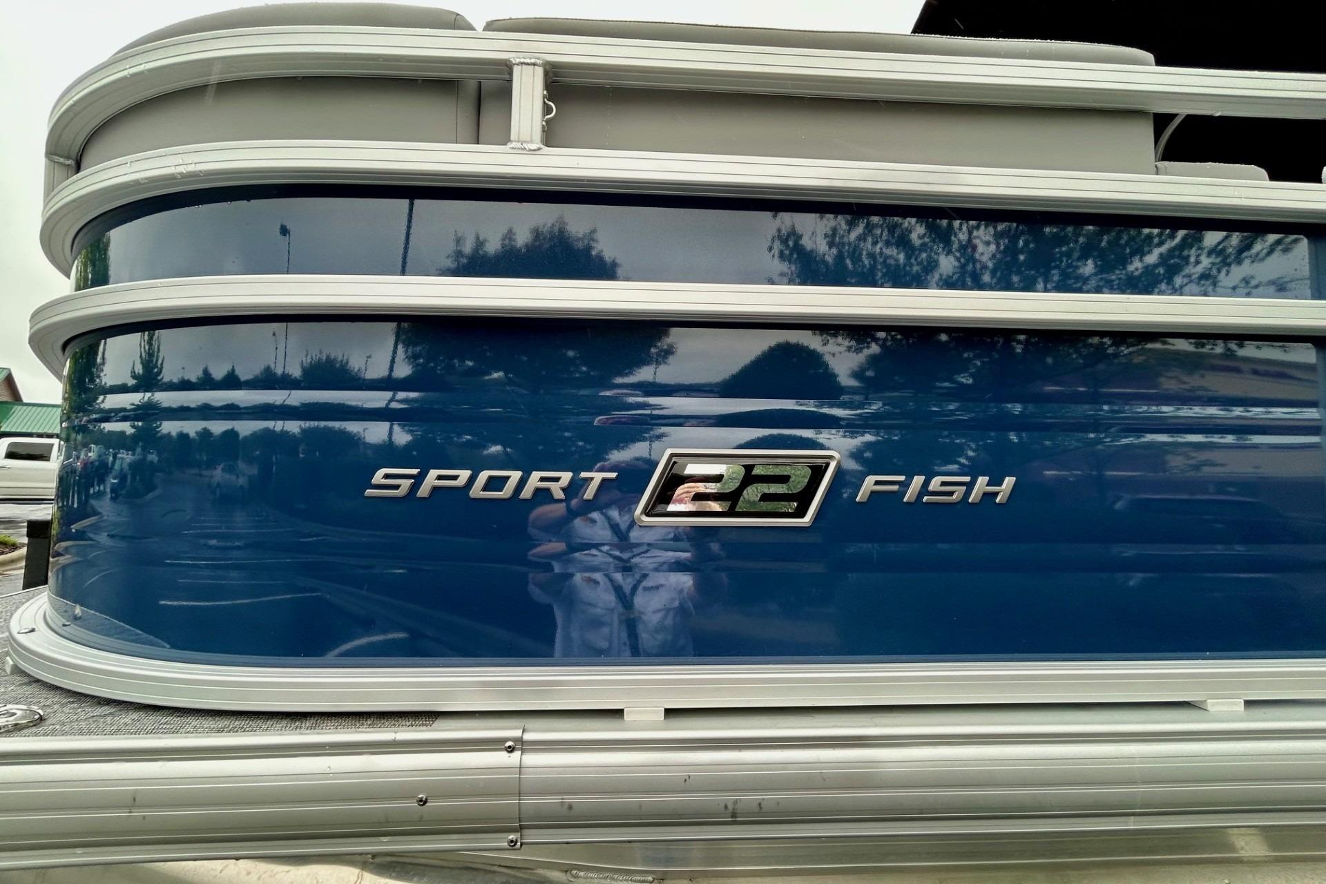 2026 Sun Tracker SportFish 22 DLX pontoon boat with blue exterior and silver accents.