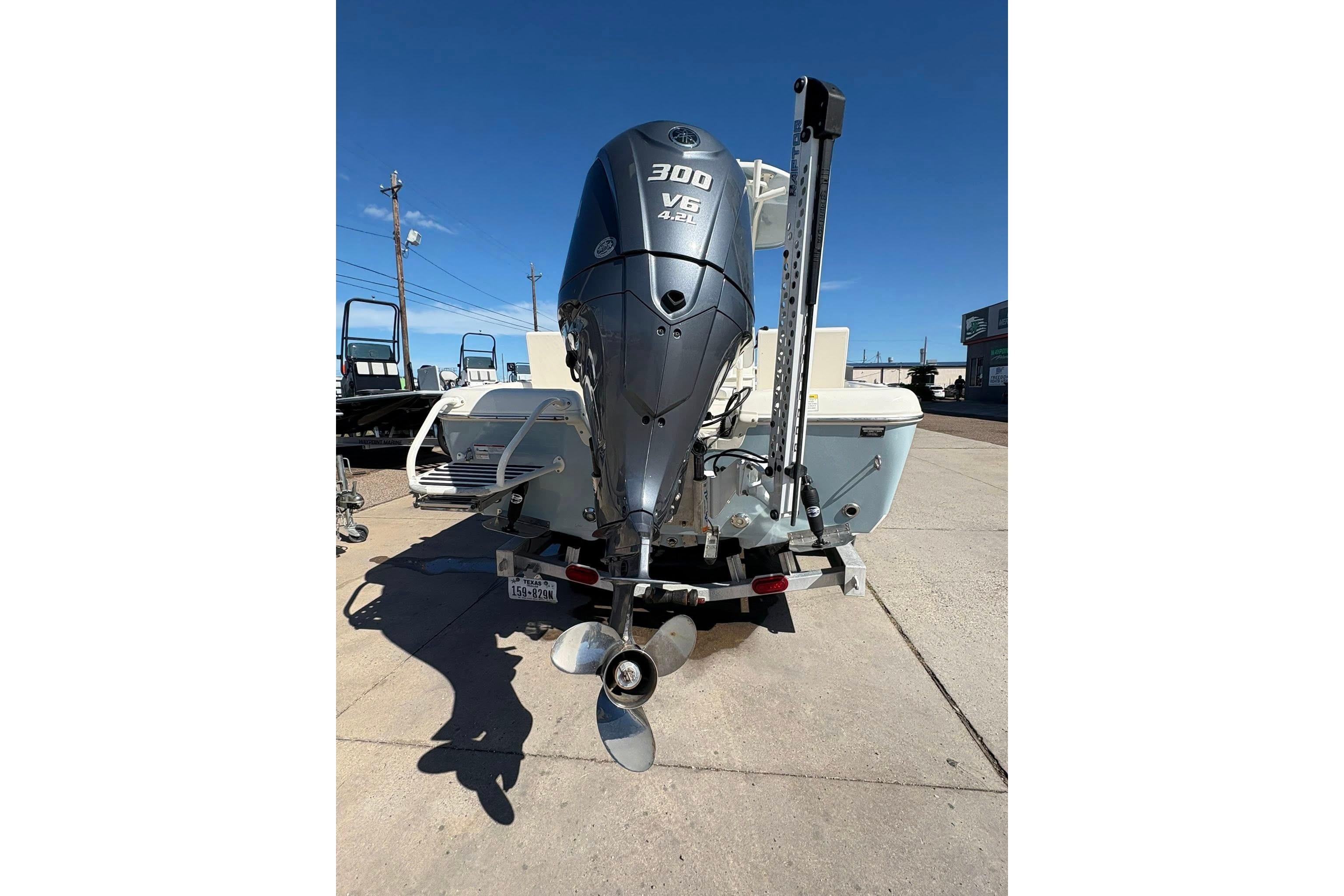 2023 Skeeter SX2550 Family boat with powerful 300 V6 engine, parked outdoors.