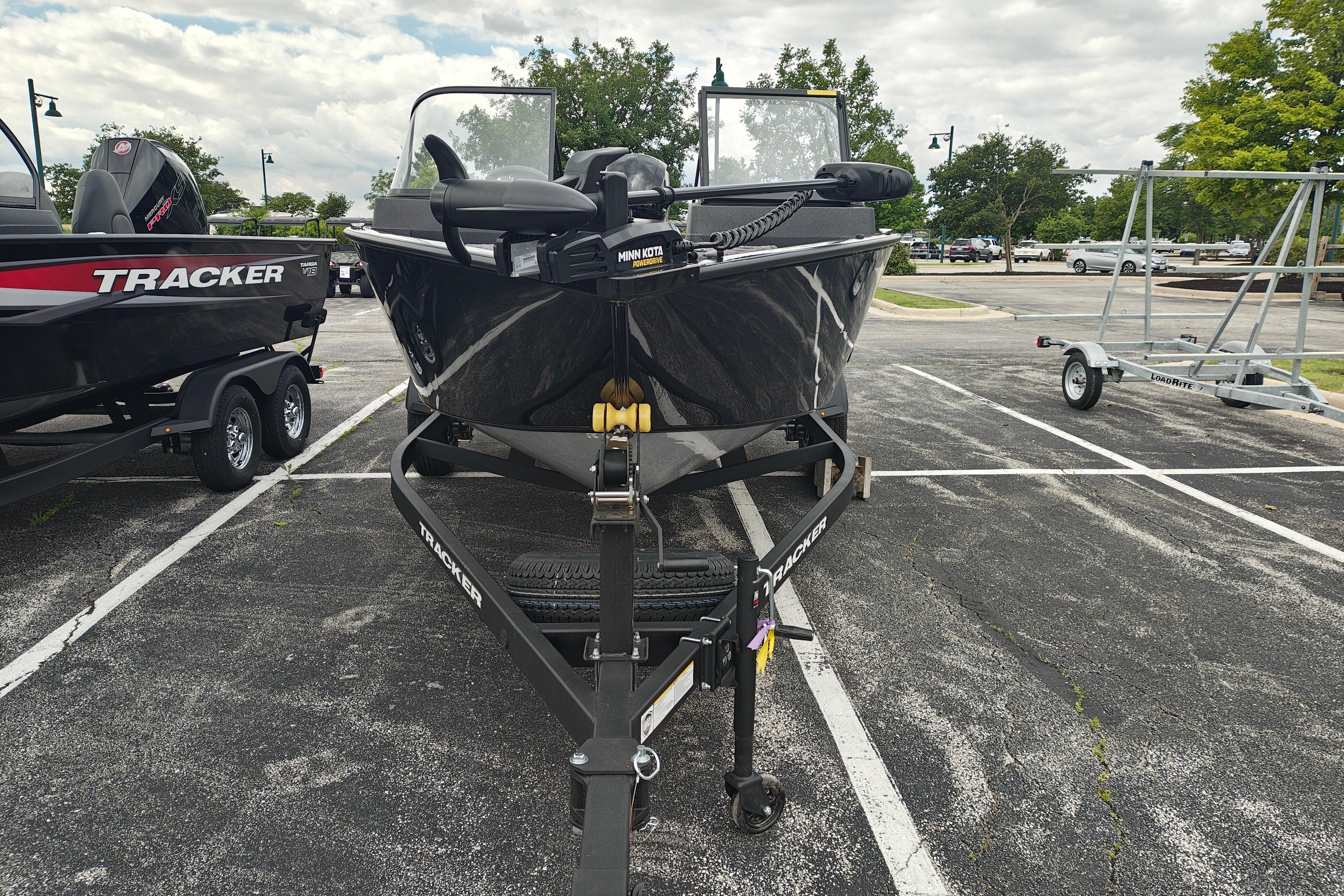 2026 Tracker Pro Guide V-175 WT boat on trailer in parking lot.