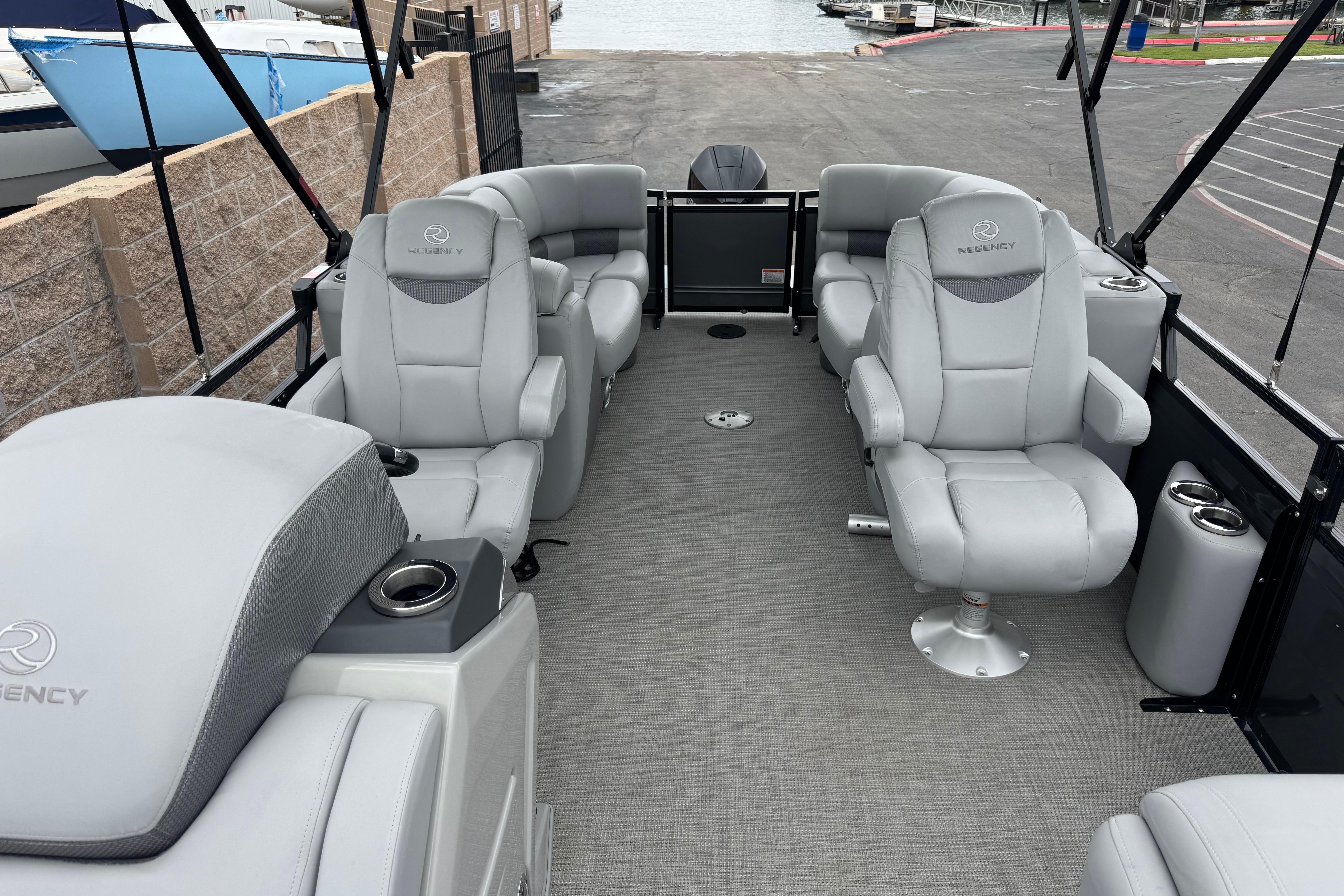 Luxurious 2023 Regency 250 LE3 pontoon boat interior with plush seating and modern design.